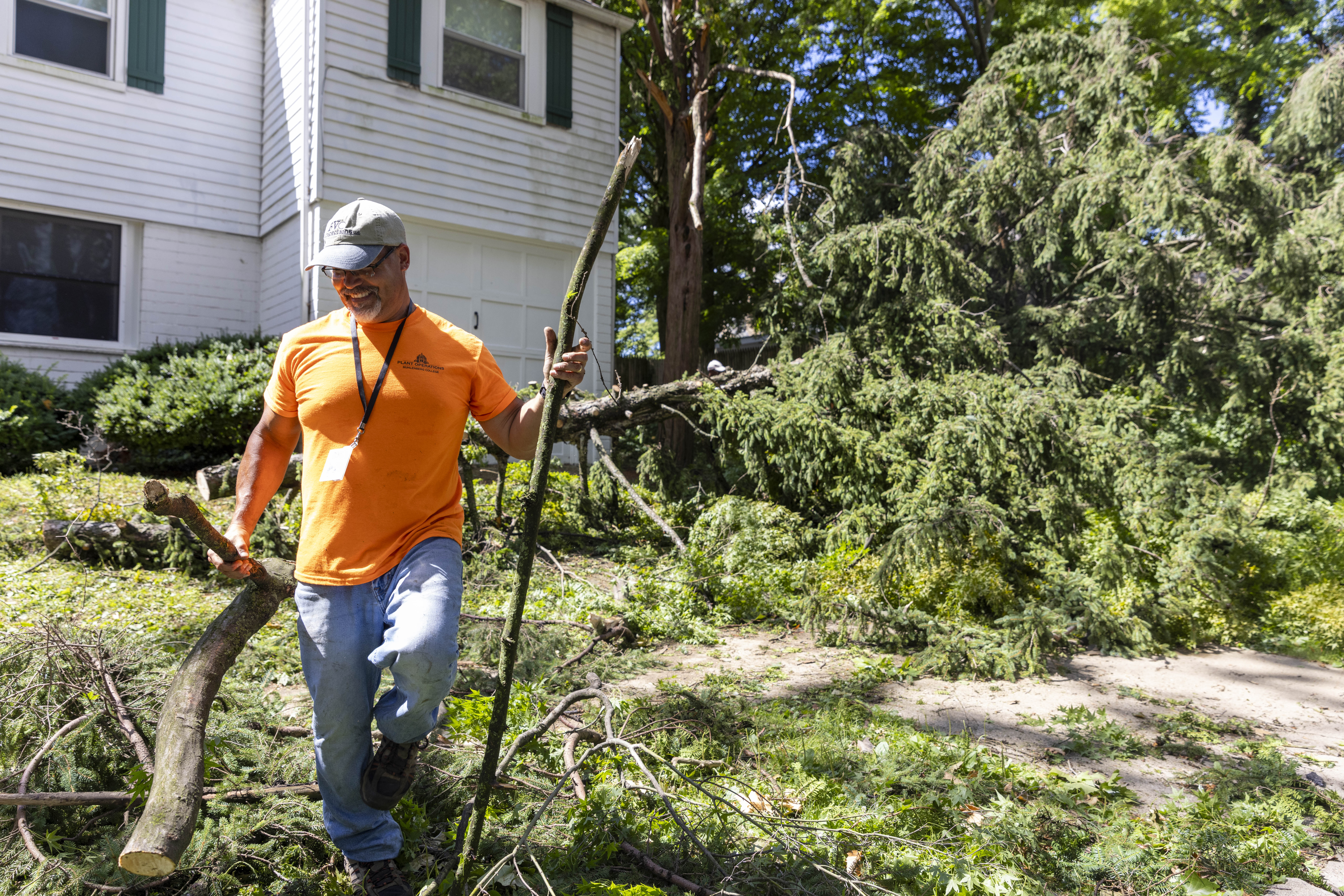 John Walsh, an employee at Muhlenberg College's Plant Operations, moves tree branches Thursday, June 27, 2024, in Allentown after a severe thunderstorm with nearly 60 mph wind gusts ripped through the Lehigh Valley the night before. (Emma Reed/The Morning Call)