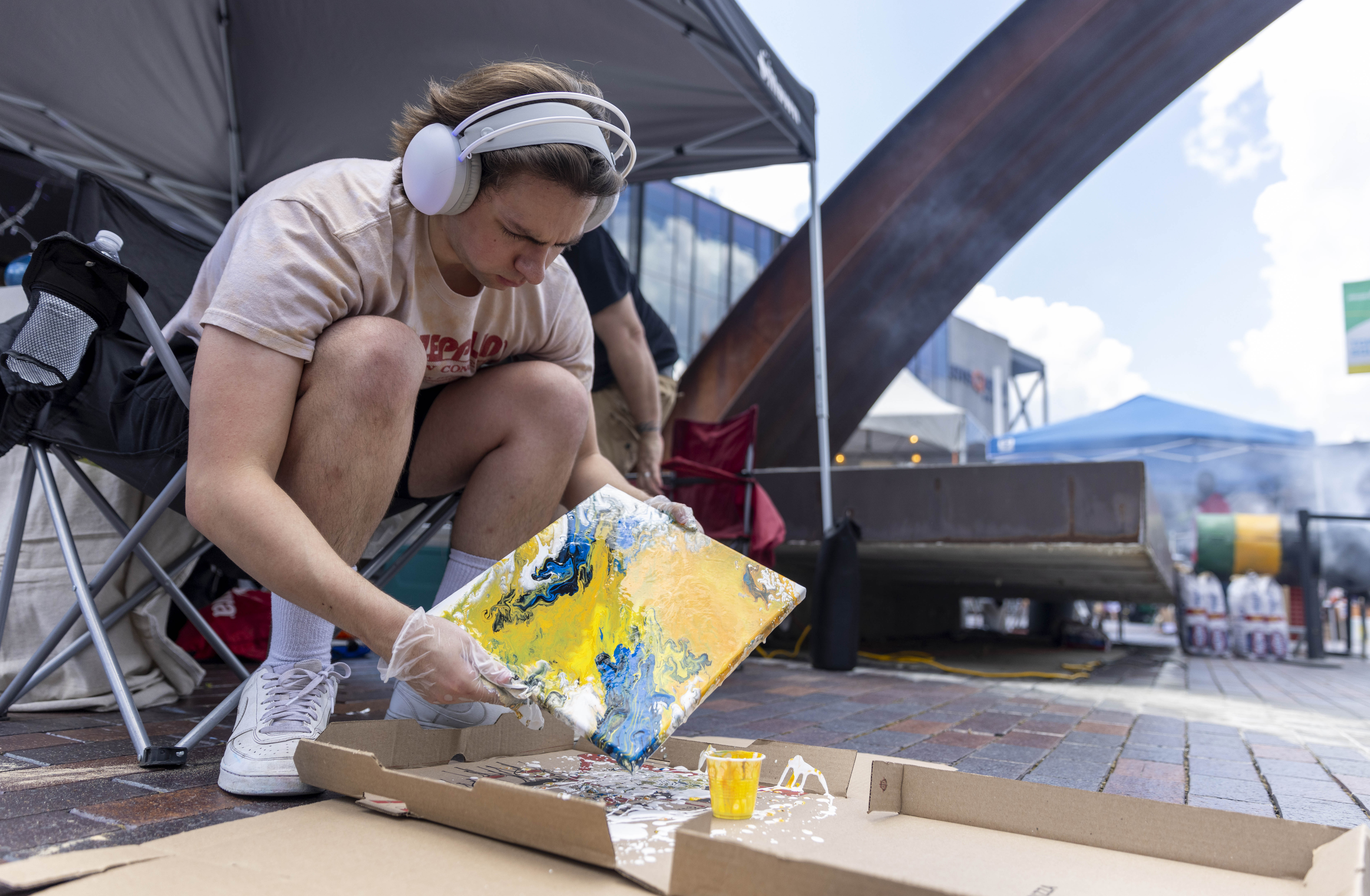 Jake Kovacs creates a flow art painting Saturday, July 6, 2024, during the One Earth ReggaeFest at SteelStacks in Bethlehem. (Emma Reed/The Morning Call)