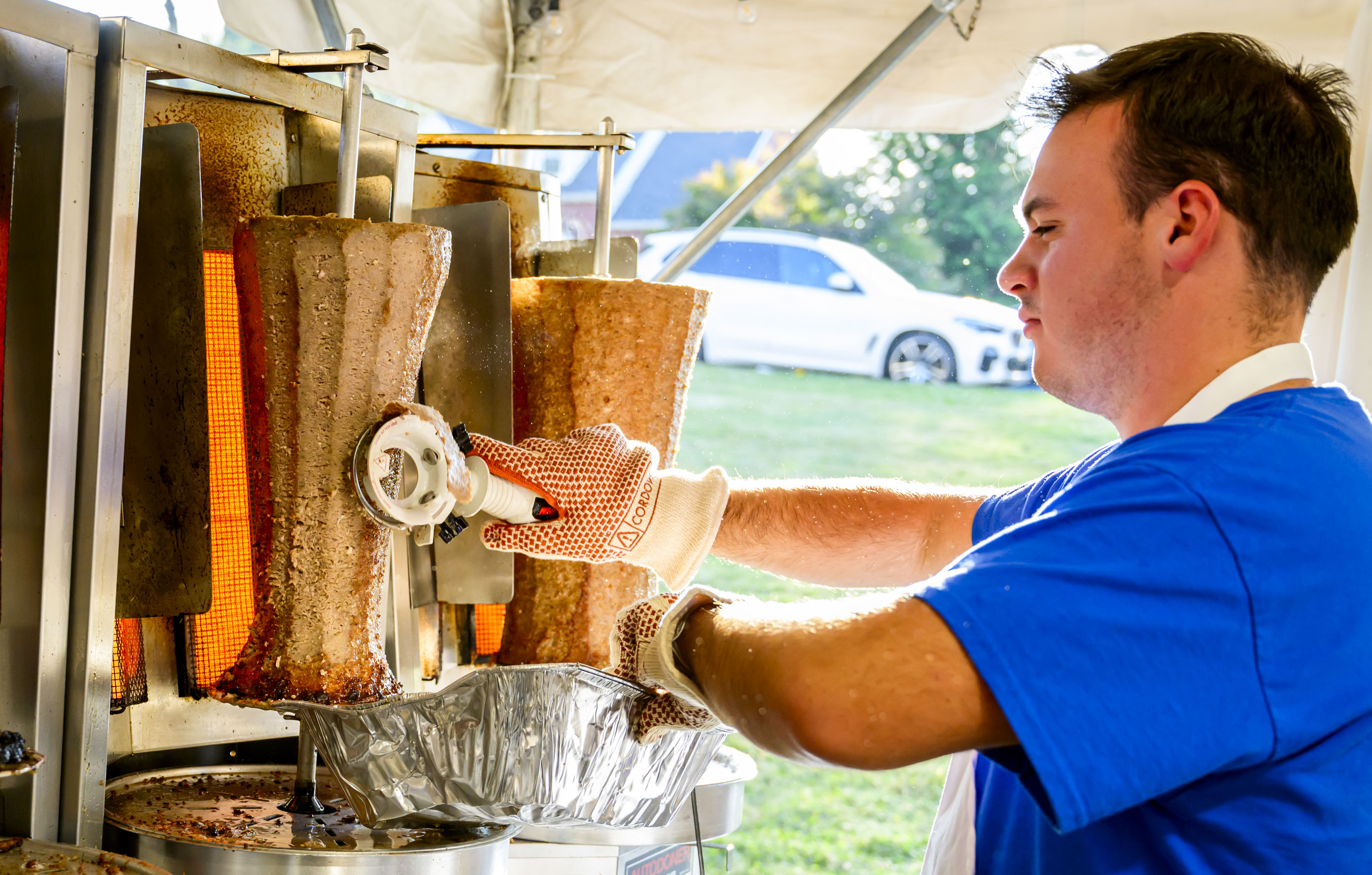 Kosta Voyiazis shaves freshly grilled meat Thursday, Sept. 19, 2024, at the St. Nicholas Greek Orthodox Cathedral's Greek Food Festival in Bethlehem. The festival runs through Sept. 22 and features music, Greek dancing, and Greek food such as gyros, souvlaki, spanakopita and desserts including baklava and kataifi. (April Gamiz/The Morning Call)