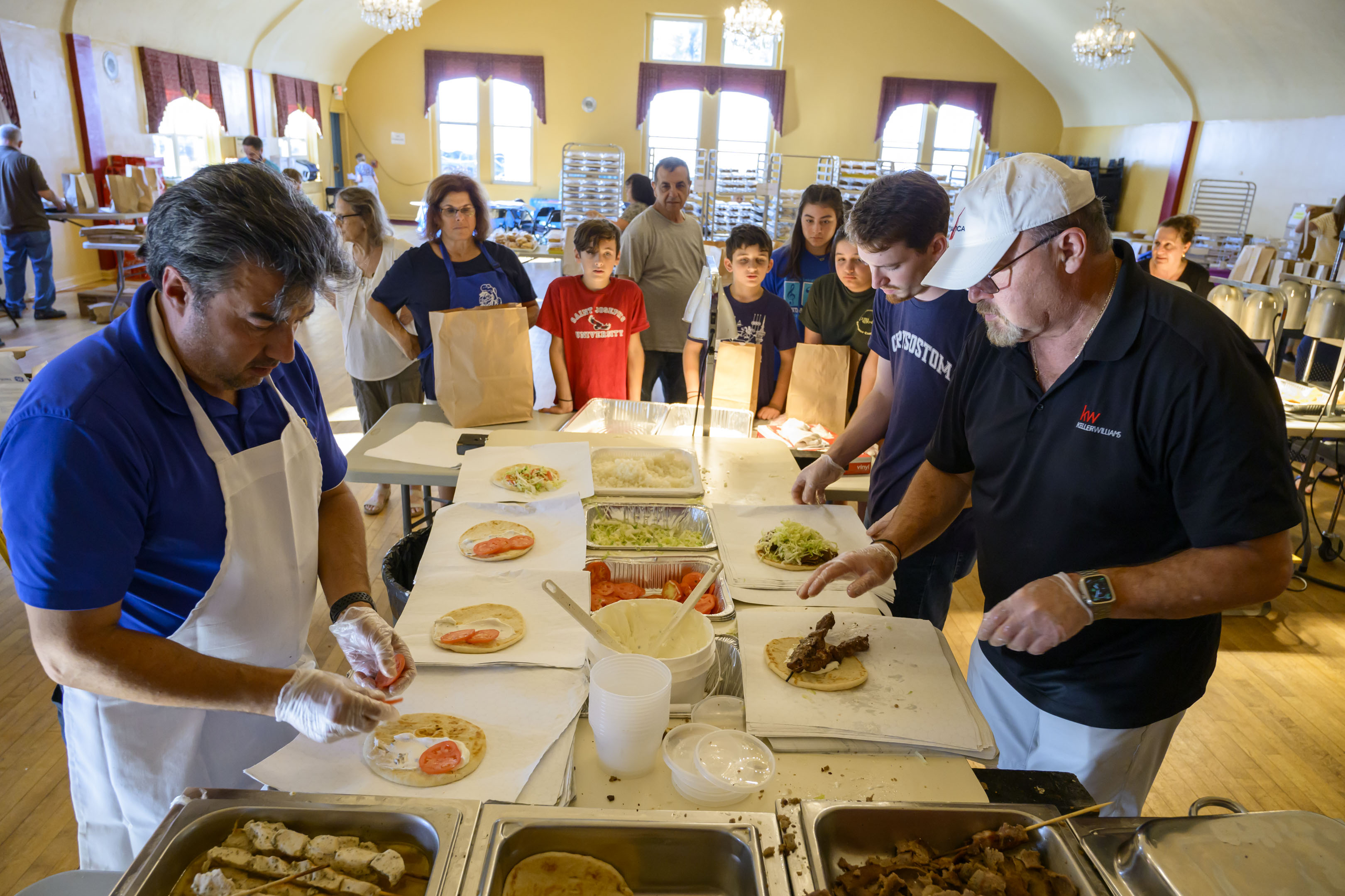 Ted Evangelou, Kostas Horiusos and Andrew Gillespie make hundreds of gyros and souvlaki on pita Thursday, Sept. 19, 2024, at the St. Nicholas Greek Orthodox Cathedral's Greek Food Festival in Bethlehem. The festival runs through Sept. 22 and features music, Greek dancing, and Greek food such as gyros, souvlaki, spanakopita and desserts including baklava and kataifi.(April Gamiz/The Morning Call)