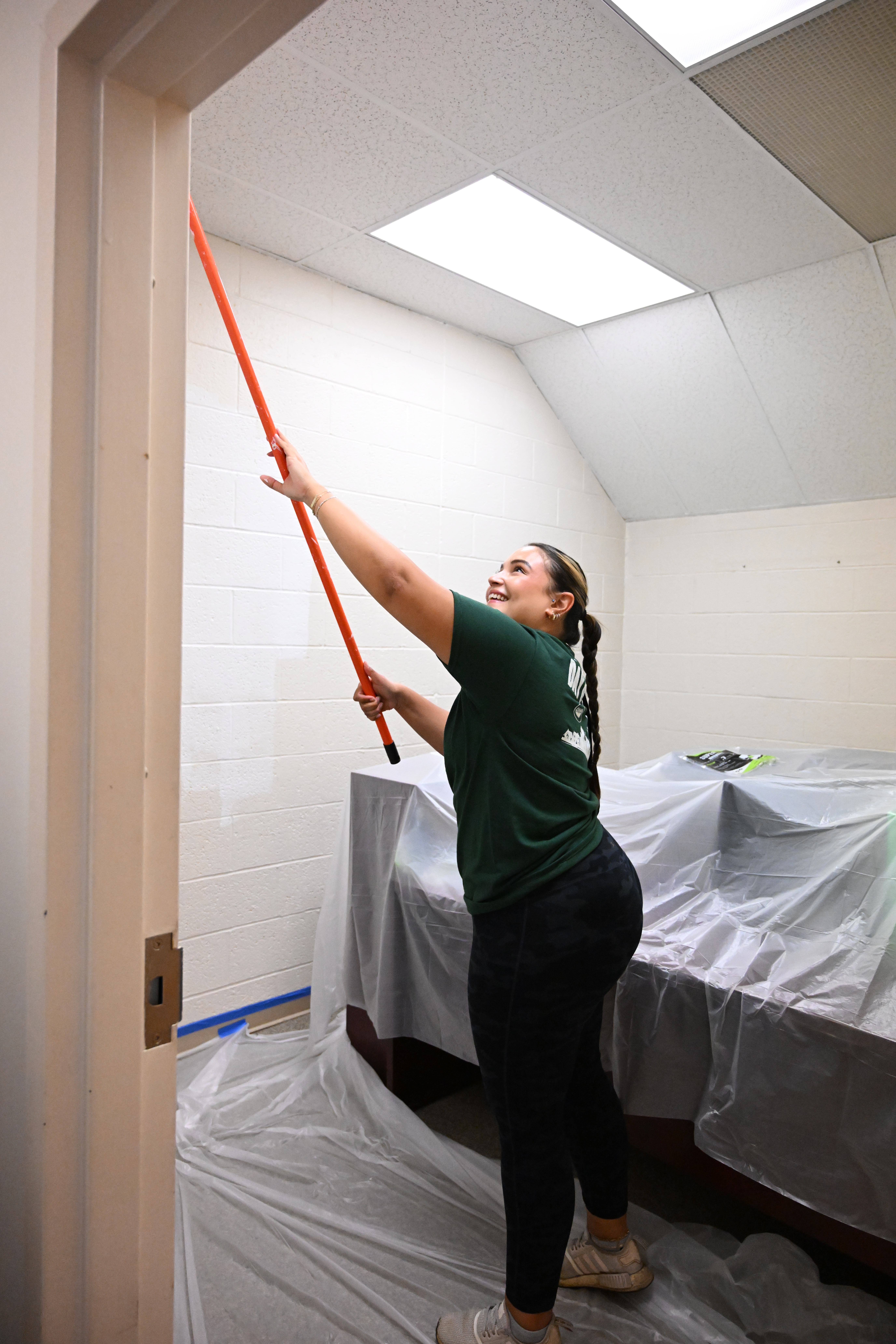 Ellie Andino, of the Lehigh Valley Chamber of Commerce, paints an office Thursday, Sept. 19, 2024, at the Boys & Girls Club of Allentown during the United Way of the Greater Lehigh Valley's 31st annual Day of Caring. Approximately 2,300 volunteers from 54 area businesses completed community service projects at dozens of nonprofits throughout Lehigh and Northampton counties. (Amy Shortell/The Morning Call)