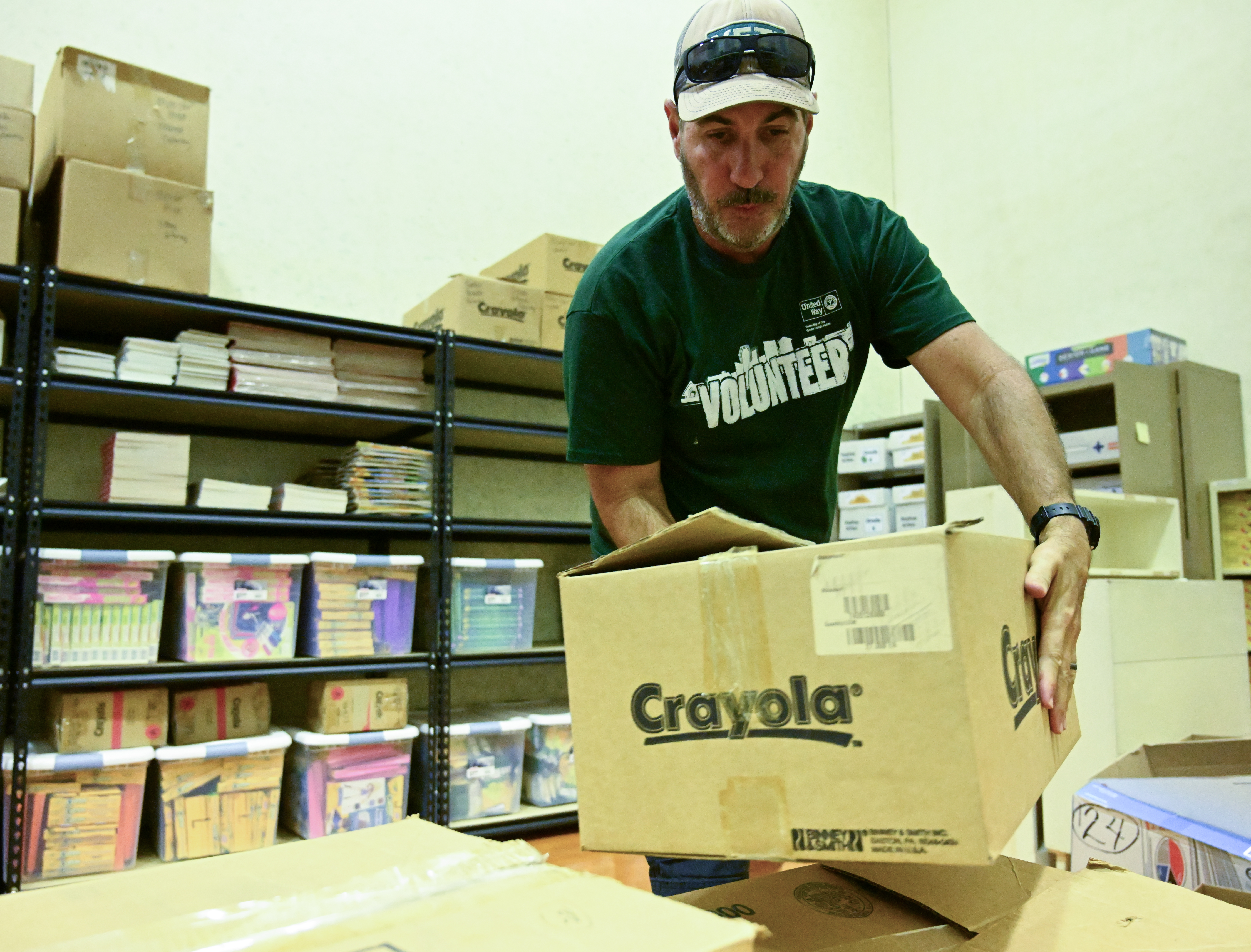 Jason Doughtry, of Quadrant Capital, organizes school supplies Thursday, Sept. 19, 2024, at the Boys & Girls Club of Allentown during the United Way of the Greater Lehigh Valley's 31st annual Day of Caring. Approximately 2,300 volunteers from 54 area businesses completed community service projects at dozens of nonprofits throughout Lehigh and Northampton counties. (Amy Shortell/The Morning Call)