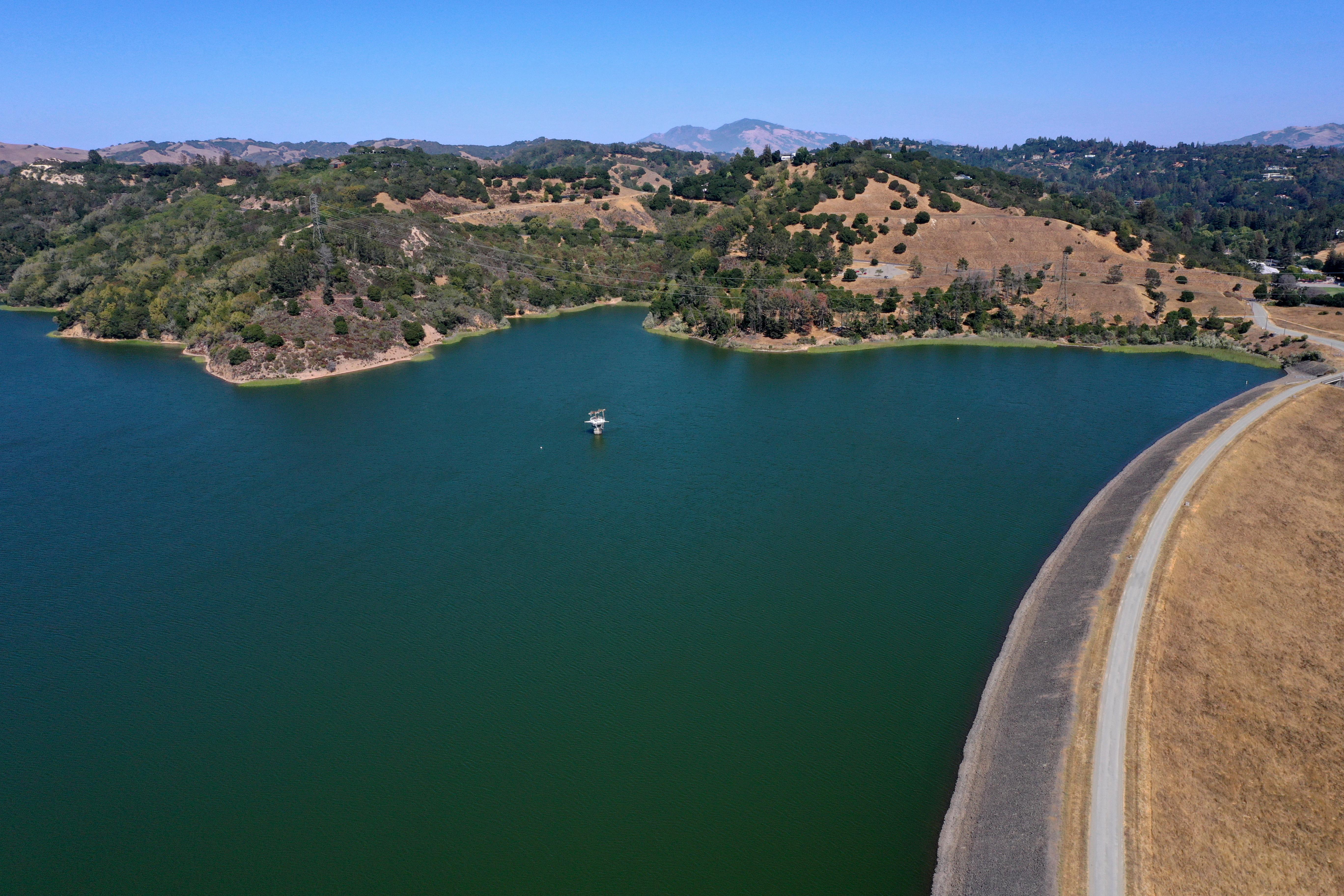 The Briones Reservoir and dam, right, are seen from this drone view in unincorporated Contra Costa County, north of Orinda, Calif., on Wednesday, July 21, 2021.