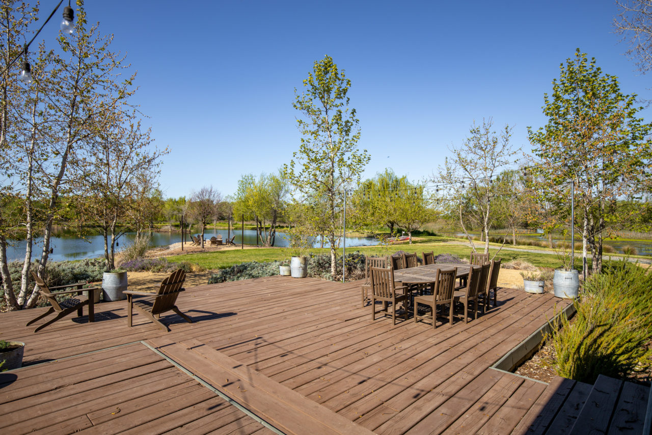An outdoor dining set near the lake.