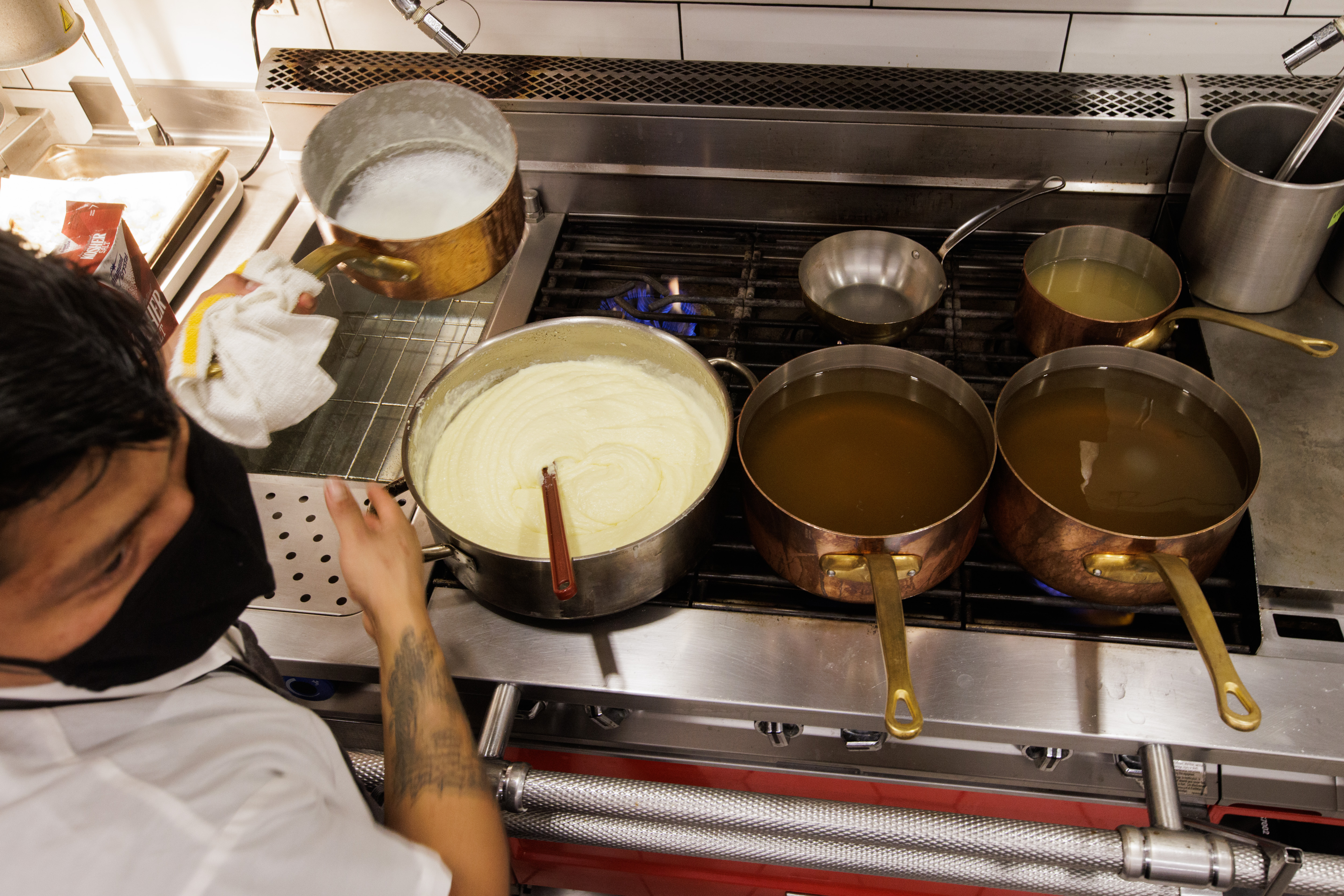 BE.STEAK.A grill cook Jesus Antonio makes mashed potatoes using a gas stove