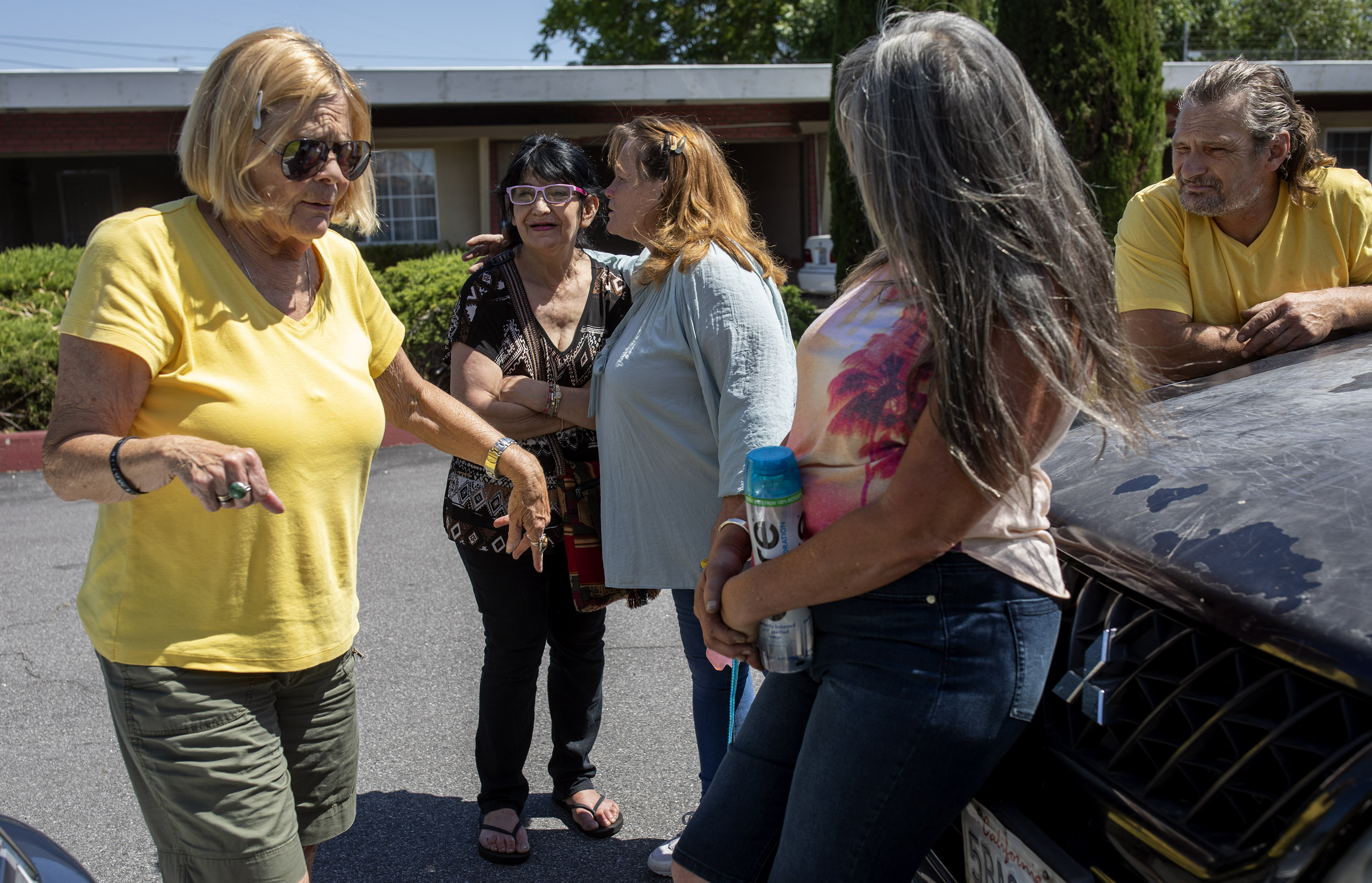 Homeless advocate Gail Osmer (left) talks with a group of homeless people in San Jose, Calif.