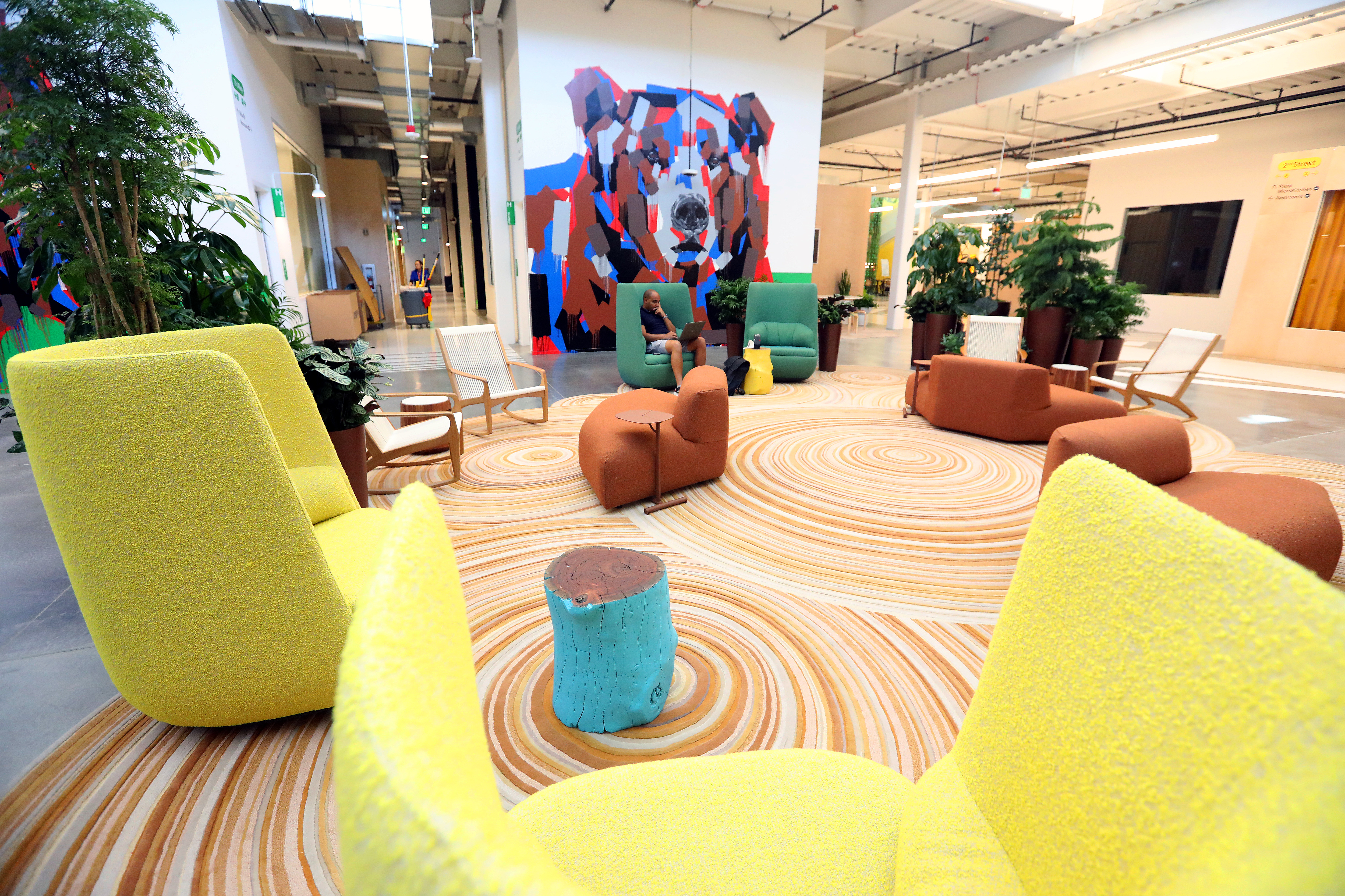 A Google employee is photographed in a gathering space at the new Bay View campus