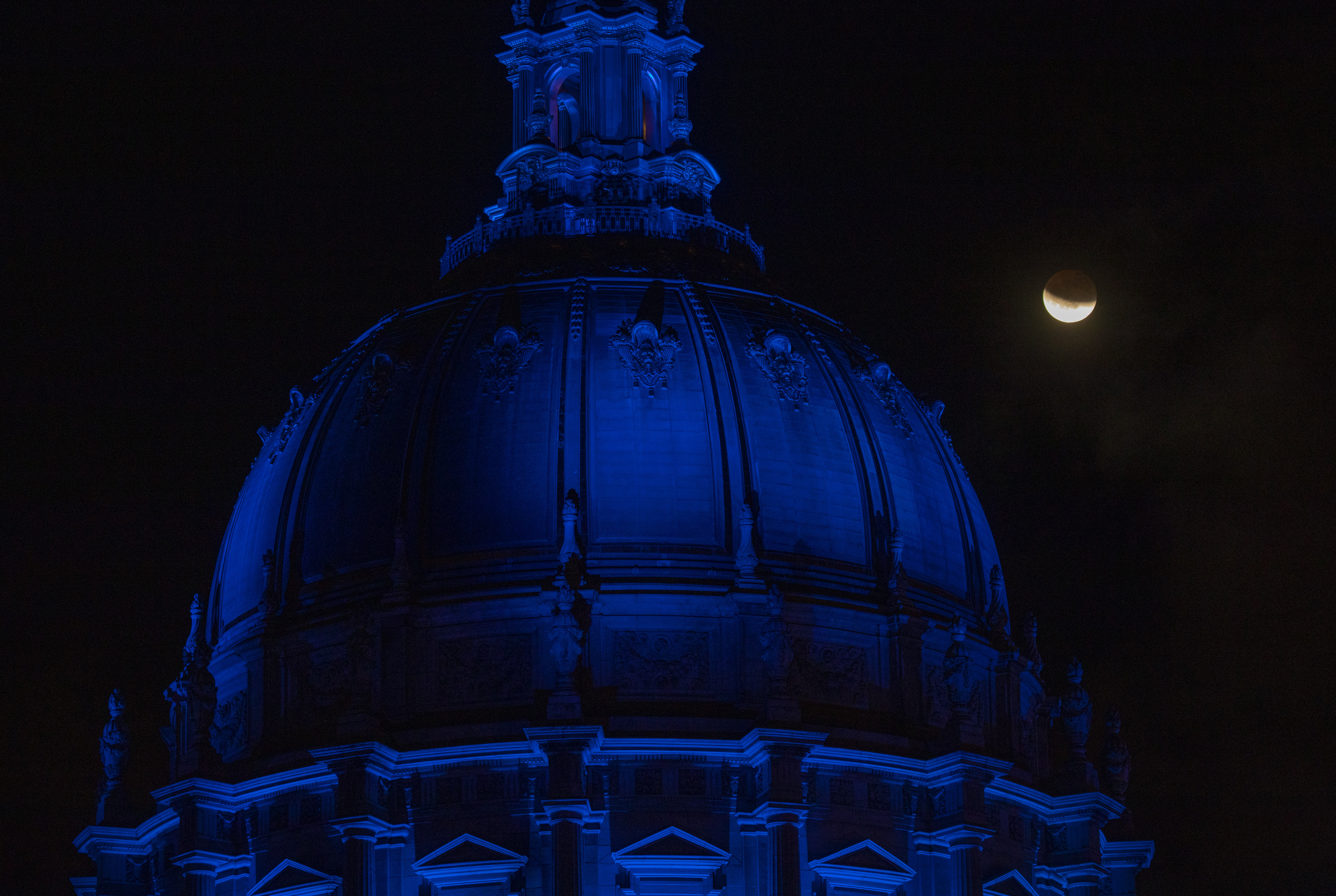 The lunar eclipse enters its final phase as the clouds clear over San Francisco City Hall, Sunday, May 15, 2022. (Photo: Karl Mondon/Bay Area News Group)