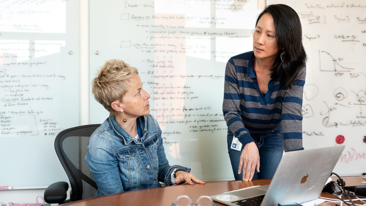 Melanie Ott, left, and Nadia Roan talk at Gladsone Institutes
