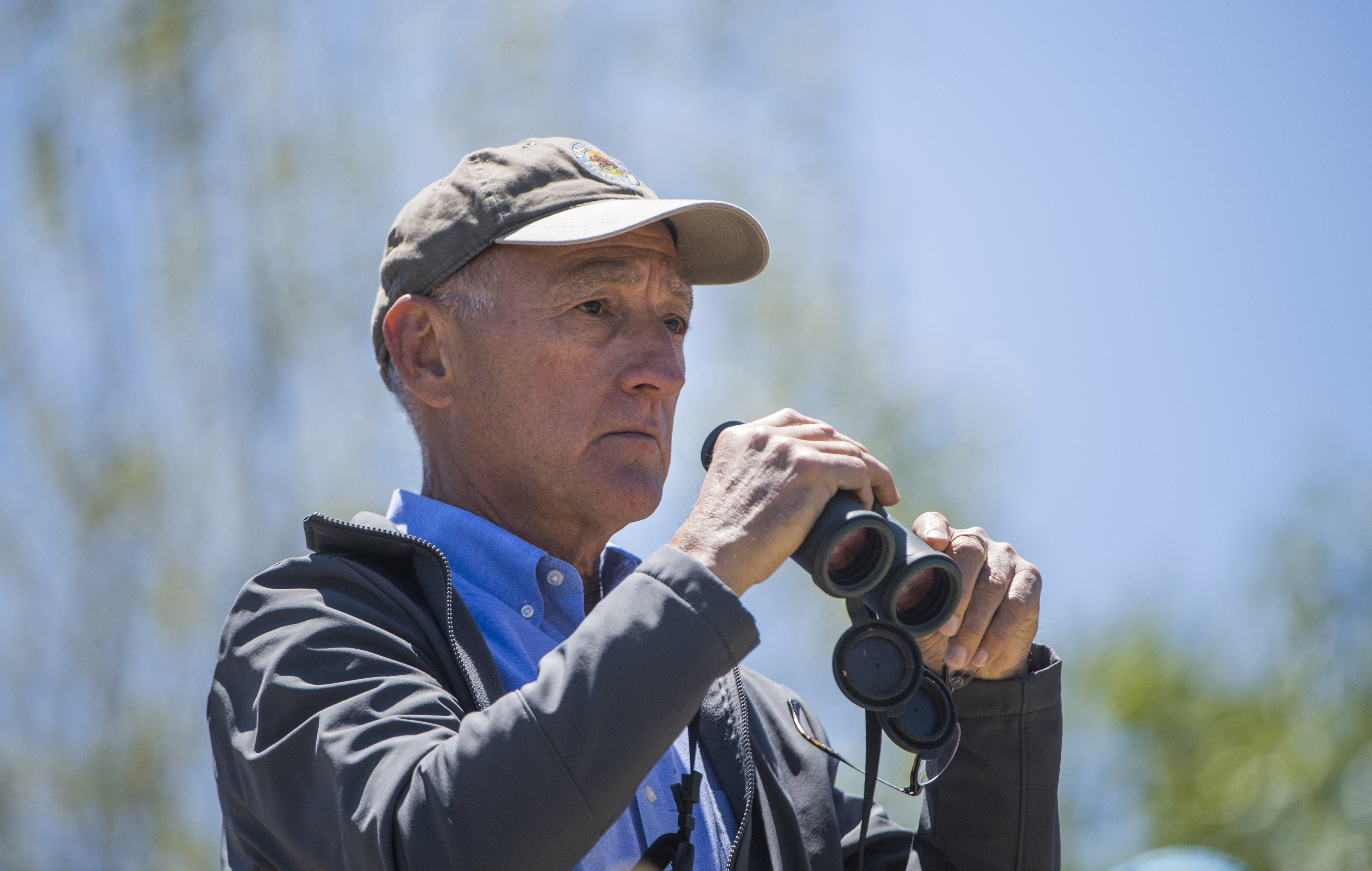 Armando Quintero, director for the California Department of Parks and Recreation, looks at birds at a new park in Modesto, Calif.