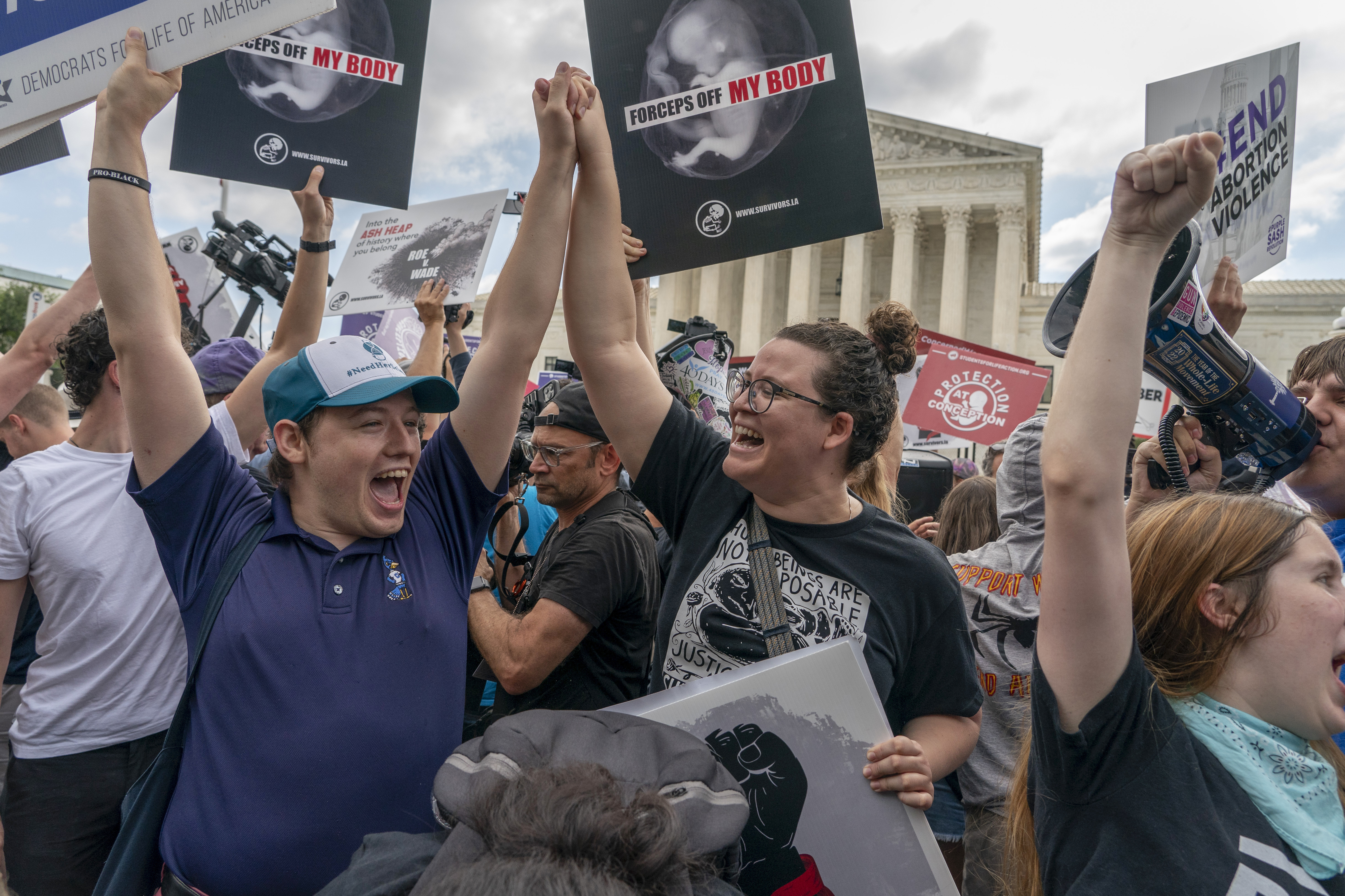 Anti-abortion protesters celebrate following Supreme Court's decision to overturn Roe v. Wade, federally protected right to abortion, in Washington, Friday, June 24, 2022. (AP Photo/Gemunu Amarasinghe)