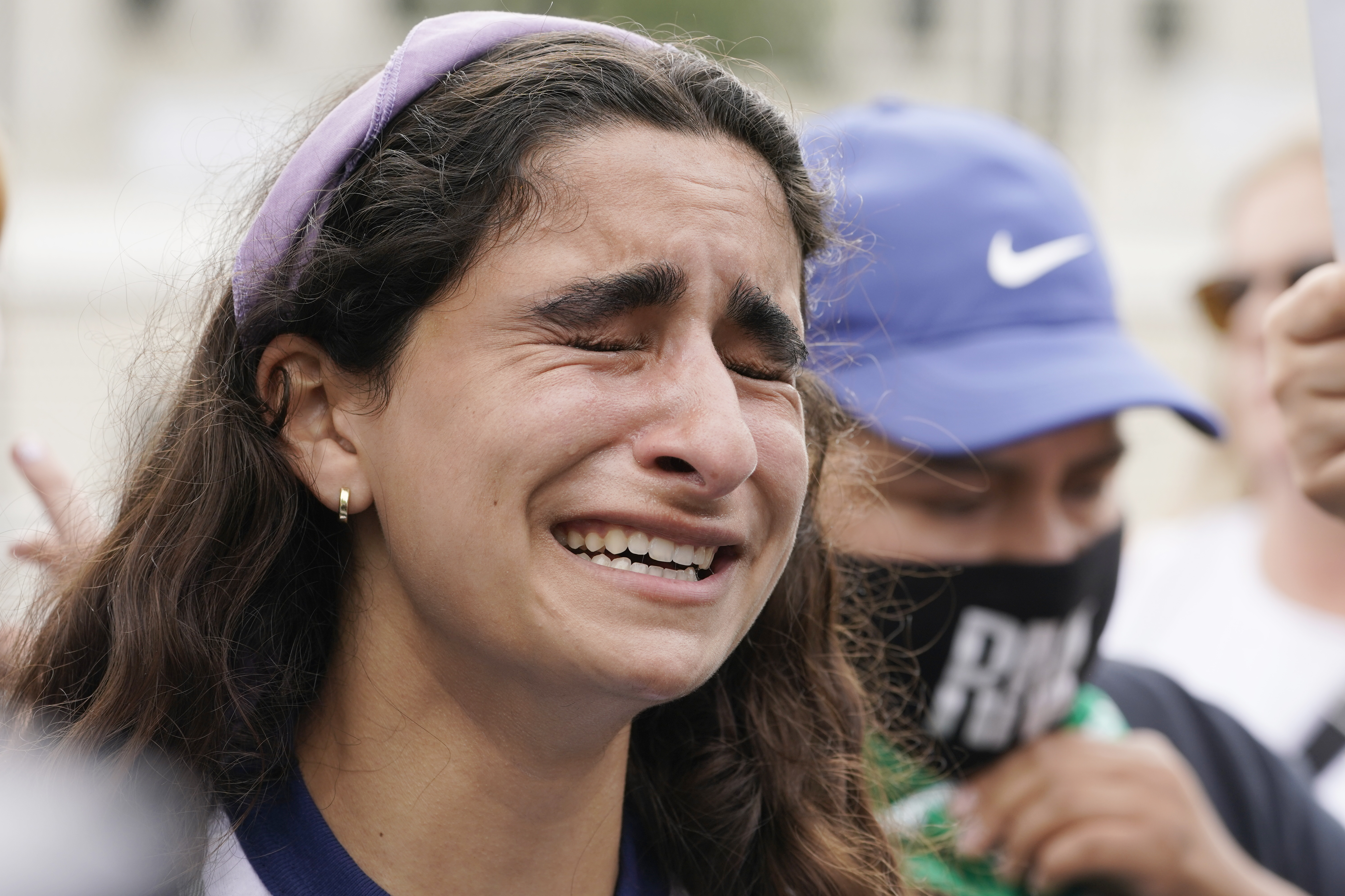 A woman upset about the abortion decision, Friday, June 24, 2022, outside the Supreme Court in Washington. (AP Photo/Steve Helber)