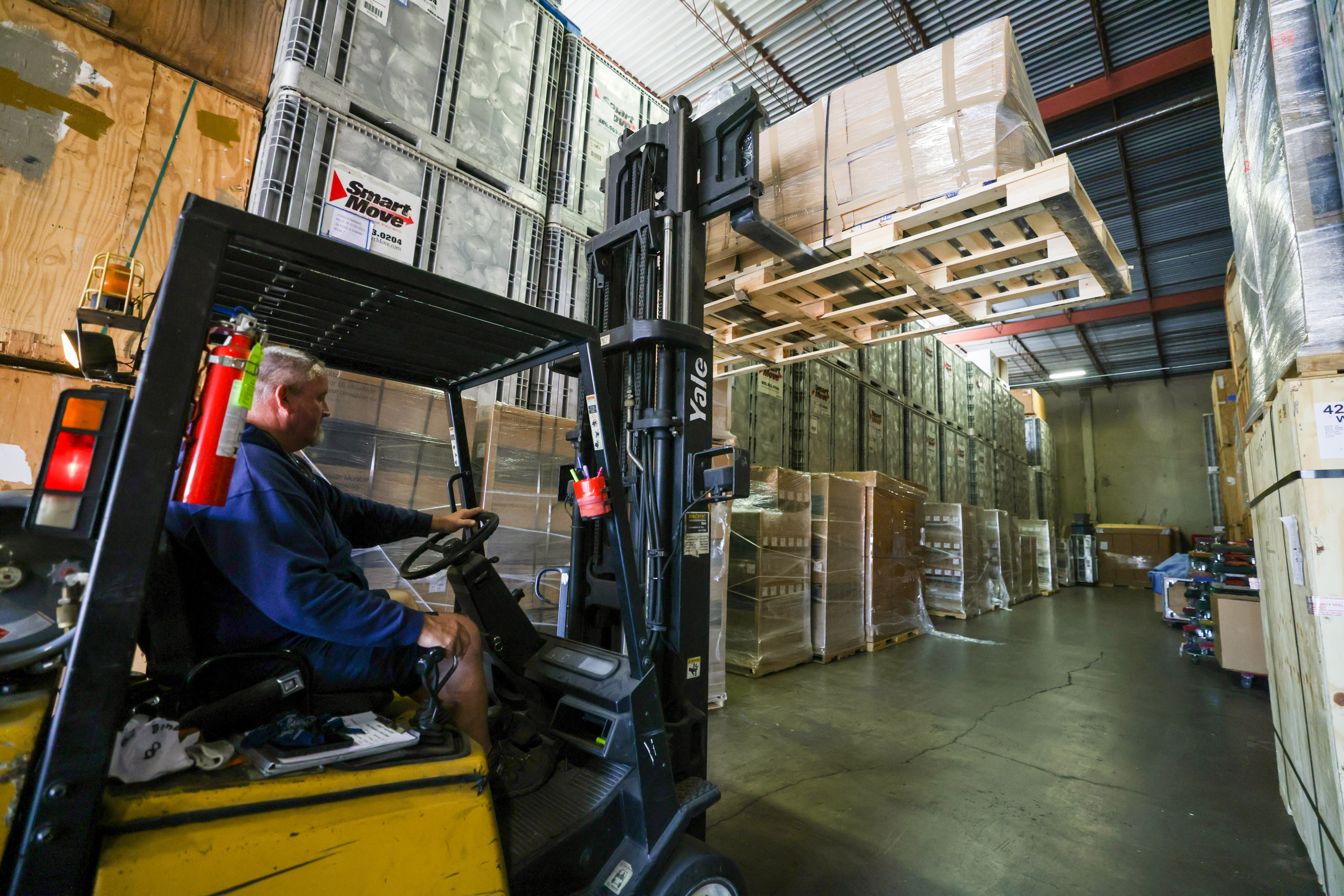 HAYWARD, CALIFORNIA - JULY 15: Mark Macy, owner of Macy Movers, operates a forklift to move containers at the Macy Movers warehouse in Hayward, Calif., on Friday, July 15, 2022. Thirty percent of the containers storing clients' belongings are waiting to be shipped out of state, mostly to Tennessee and Texas, Mark said. (Ray Chavez/Bay Area News Group)