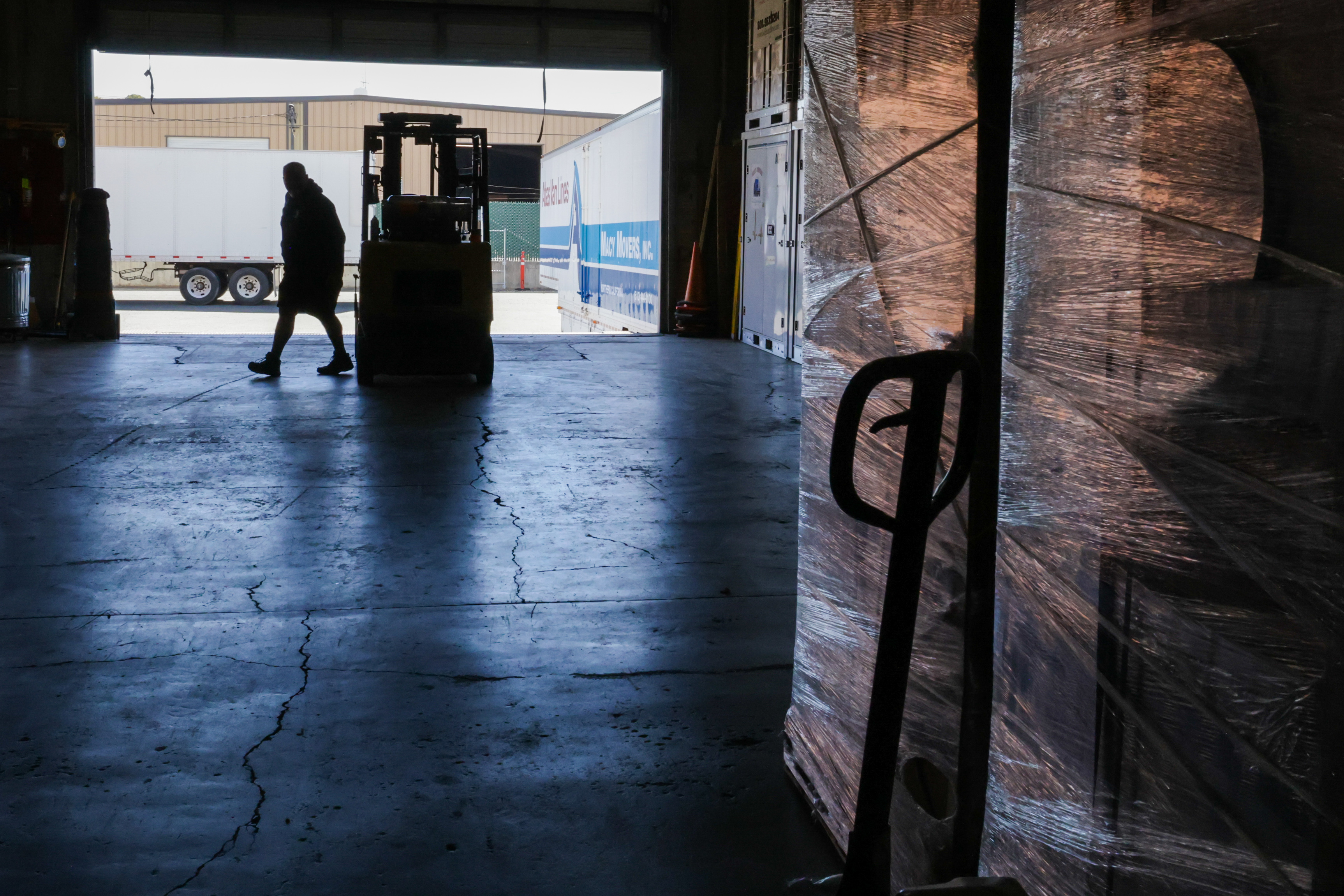 HAYWARD, CALIFORNIA - JULY 15: Mark Macy, owner of Macy Movers, operates a forklift to move containers at the Macy Movers warehouse in Hayward, Calif., on Friday, July 15, 2022. Thirty percent of the containers storing clients' belongings are waiting to be shipped out of state, mostly to Tennessee and Texas, Mark said. (Ray Chavez/Bay Area News Group)