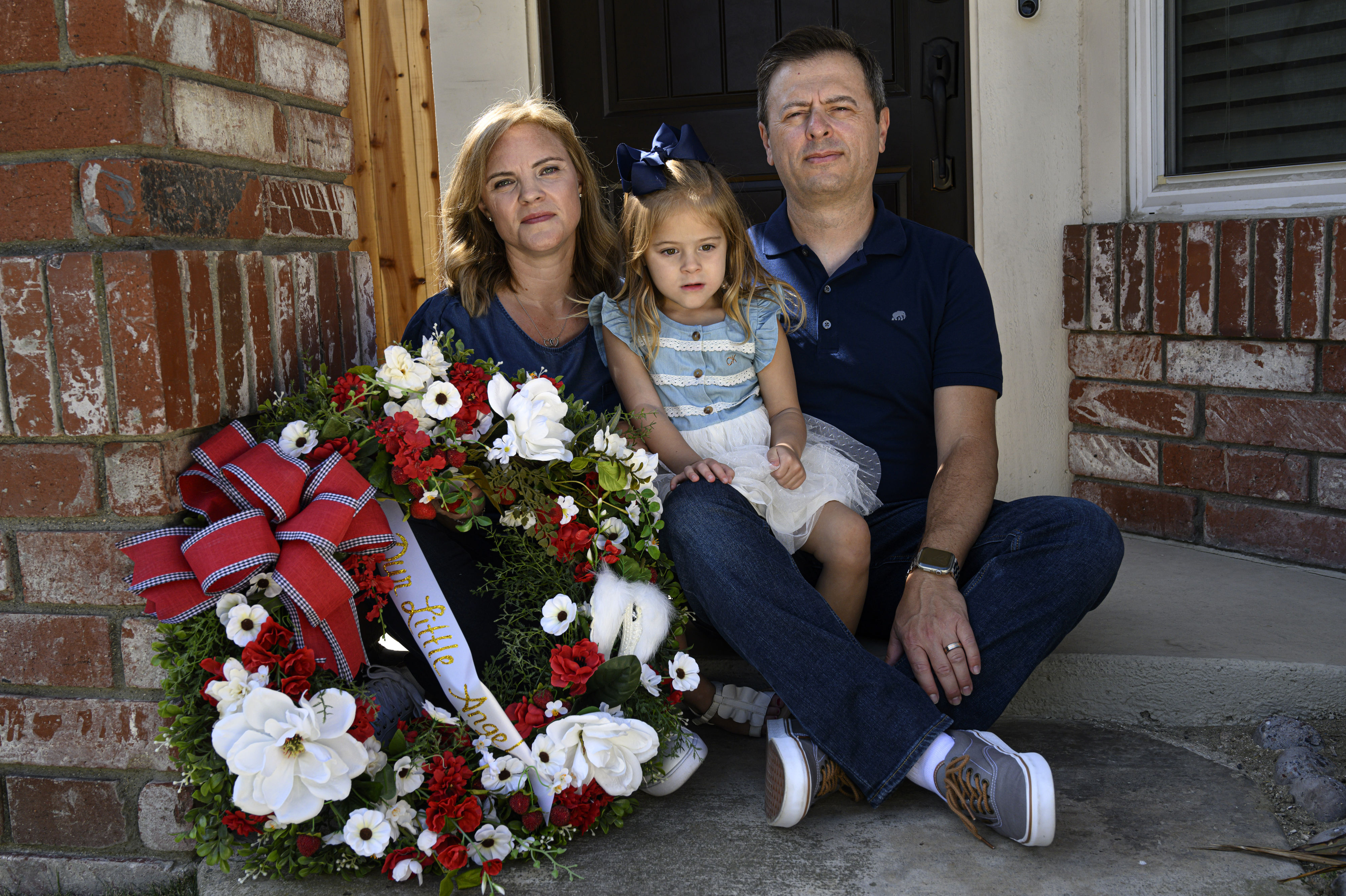 Joy and Joe Pileggi and their 3-year-old daughter, Elianna, pose on Monday, July 25, 2022 in Anaheim with a wreath in memory of the baby they lost recently after birth. Pileggi donated her breast milk for 11 months, totaling 11,000 ounces. (Photo by Mindy Schauer, Orange County Register/SCNG)