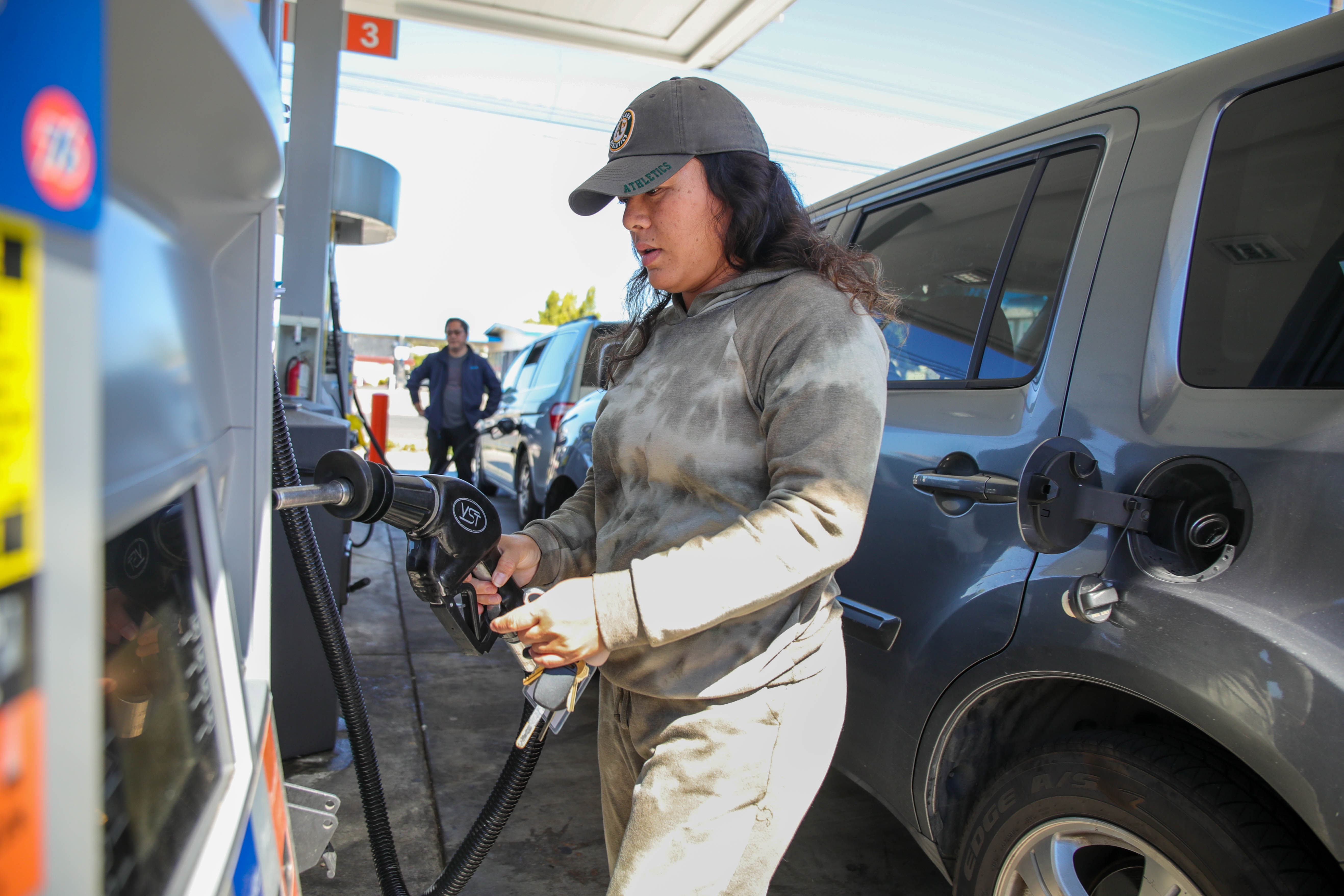 OAKLAND, CALIFORNIA - SEPTEMBER 23: Sonya Khvann, of Oakland, fills up her SUV at a 76 gas station in Alameda, Calif., on Friday, Sept. 23, 2022. The premium gas at this station is $6.29 per gallon while the Chevron gas station across the street cost $6.59. (Ray Chavez/Bay Area News Group)