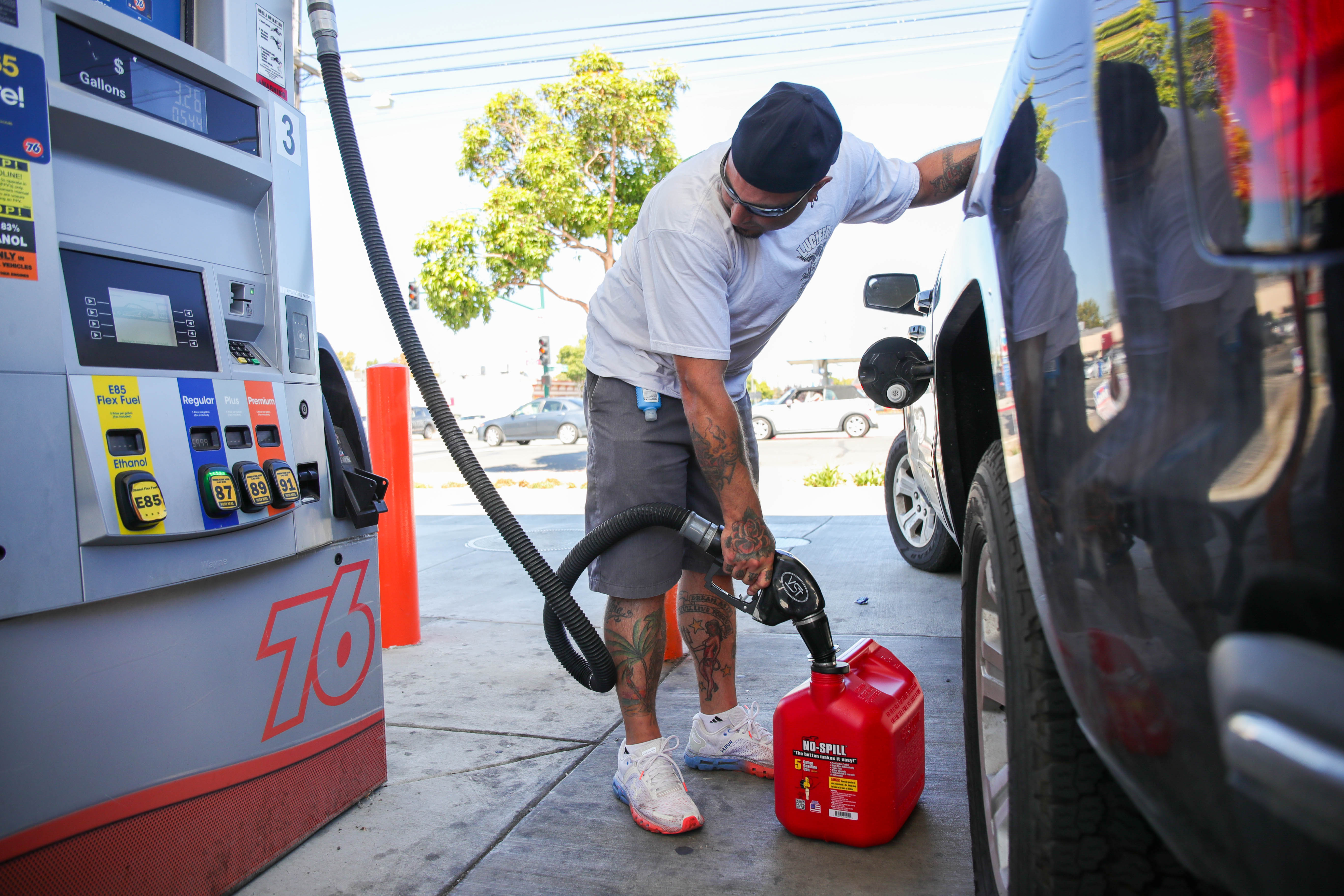 OAKLAND, CALIFORNIA - SEPTEMBER 23: Chris Perez, of Alameda, fills a portable gas container in addition to his truck at a 76 gas station in Alameda, Calif., on Friday, Sept. 23, 2022. The premium gas at this station is $6.29 per gallon while the Chevron gas station across the street is cost $6.59. (Ray Chavez/Bay Area News Group)