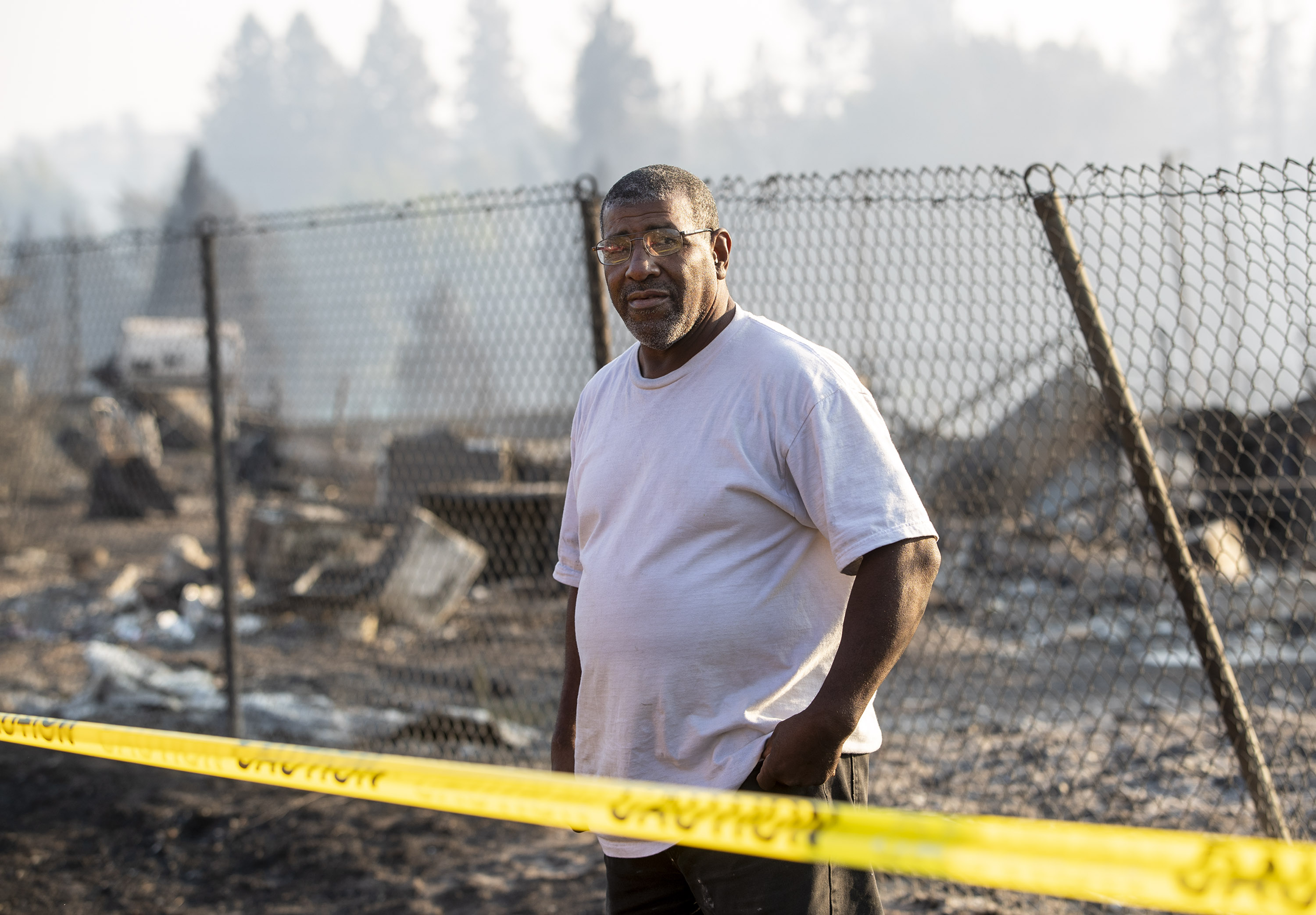 Dave Rodgers visits the ruins of his home in the Lincoln Heights neighborhood of Weed, Calif.,