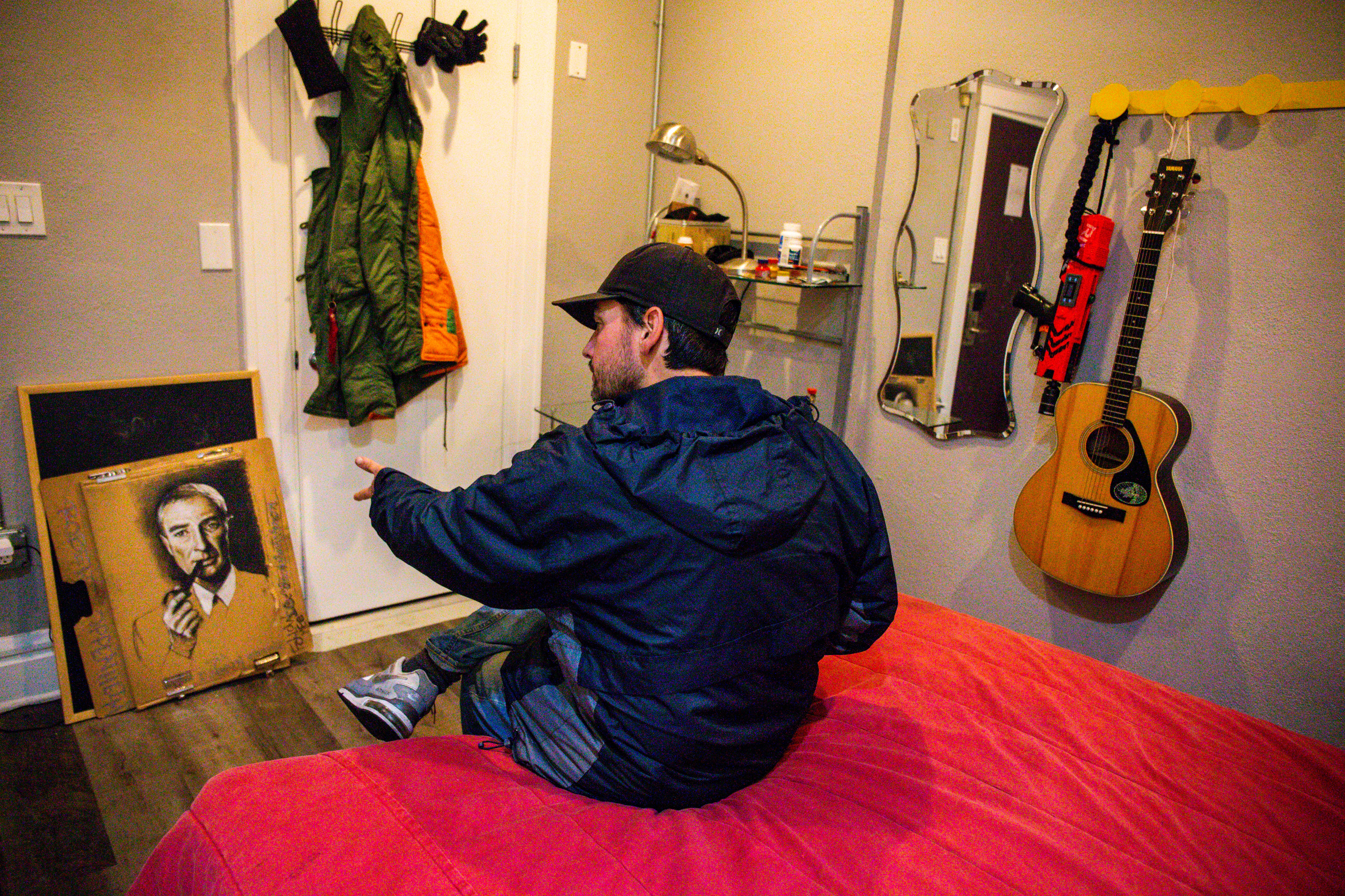 Artist Daniel McClenon, who was homeless, shows his latest work in process, a charcoal portrait on a cardboard of Robert Oppenheimer, known as the father of the atomic bomb, at his temporary housing in San Francisco, Calif., on Thursday, Oct. 6, 2022.