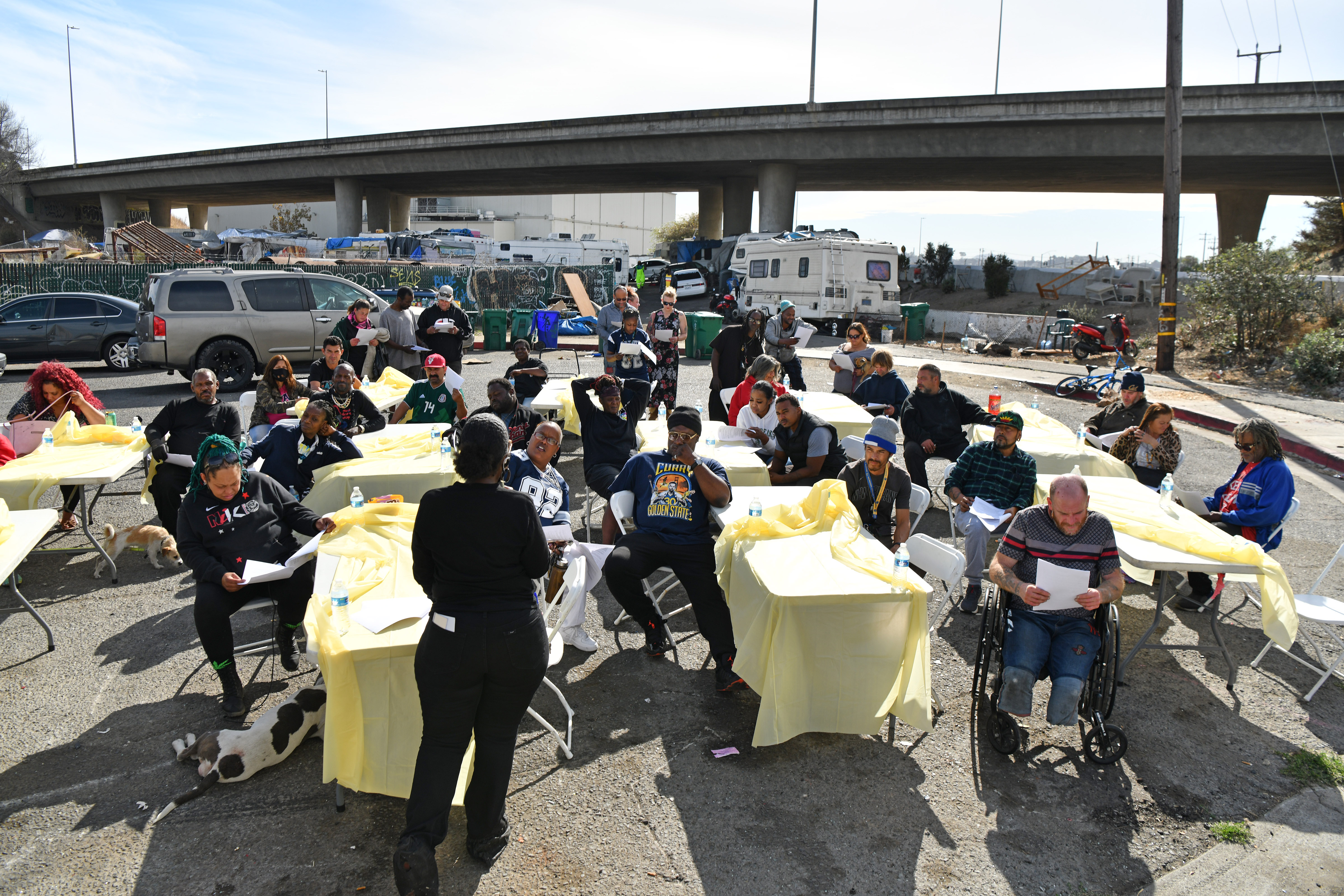 Vanessa with Way2Love Inc. speaks to camp residents living in a homeless encampment near Castro Street in Richmond, Calif., on Friday, Oct. 28, 2022. The city of Richmond received $4.8 million in February to clear the encampment. (Jose Carlos Fajardo/Bay Area News Group)