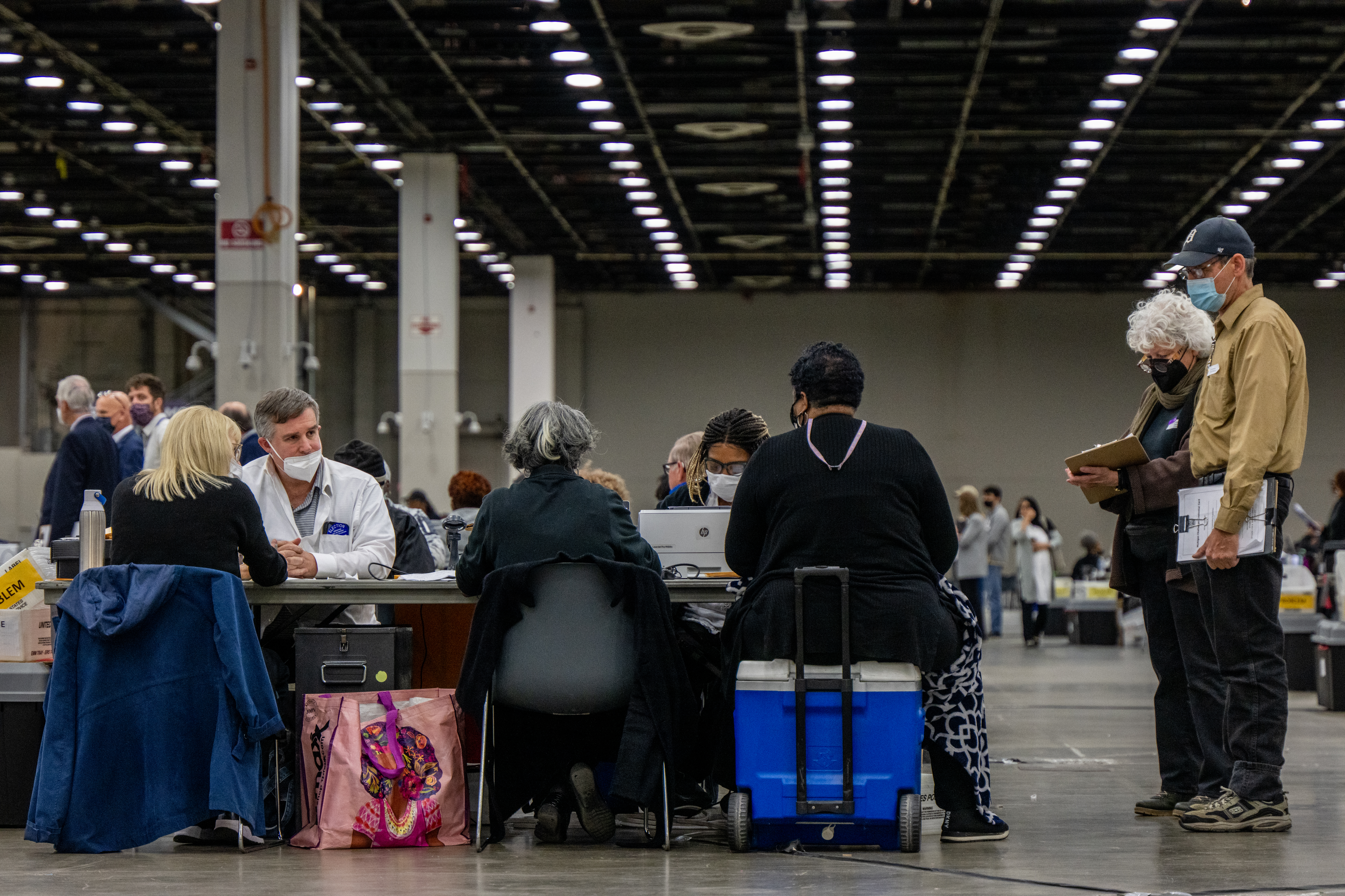 Poll challengers oversee election inspectors at the Huntington Place convention center on November 08, 2022 in Detroit, Michigan. (Photo by Brandon Bell/Getty Images)