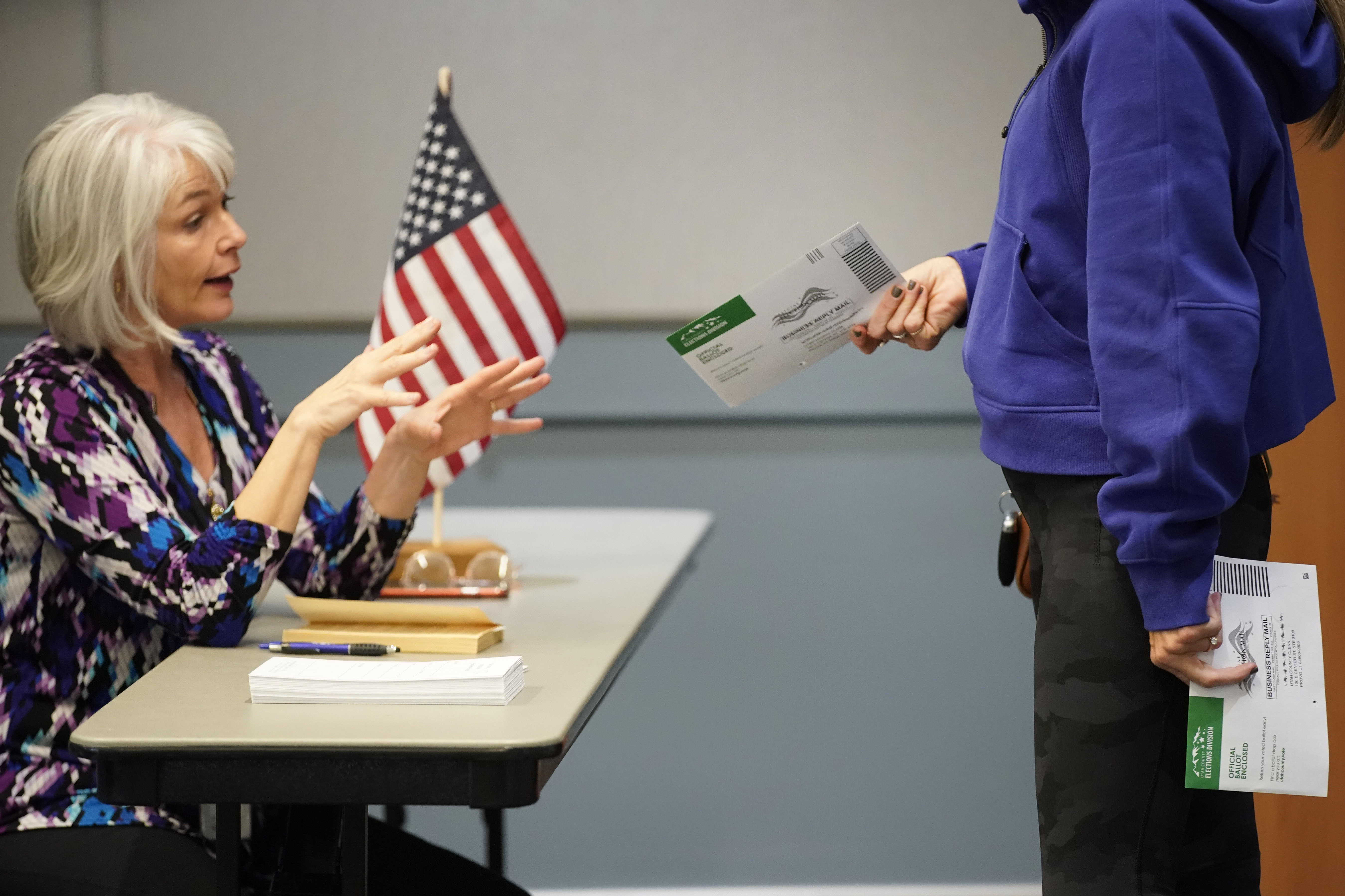 A voter gets information on where to drop off her ballots at the Utah County Justice and Health center on November 8, 2022 in Provo, Utah. (Photo by George Frey/Getty Images)