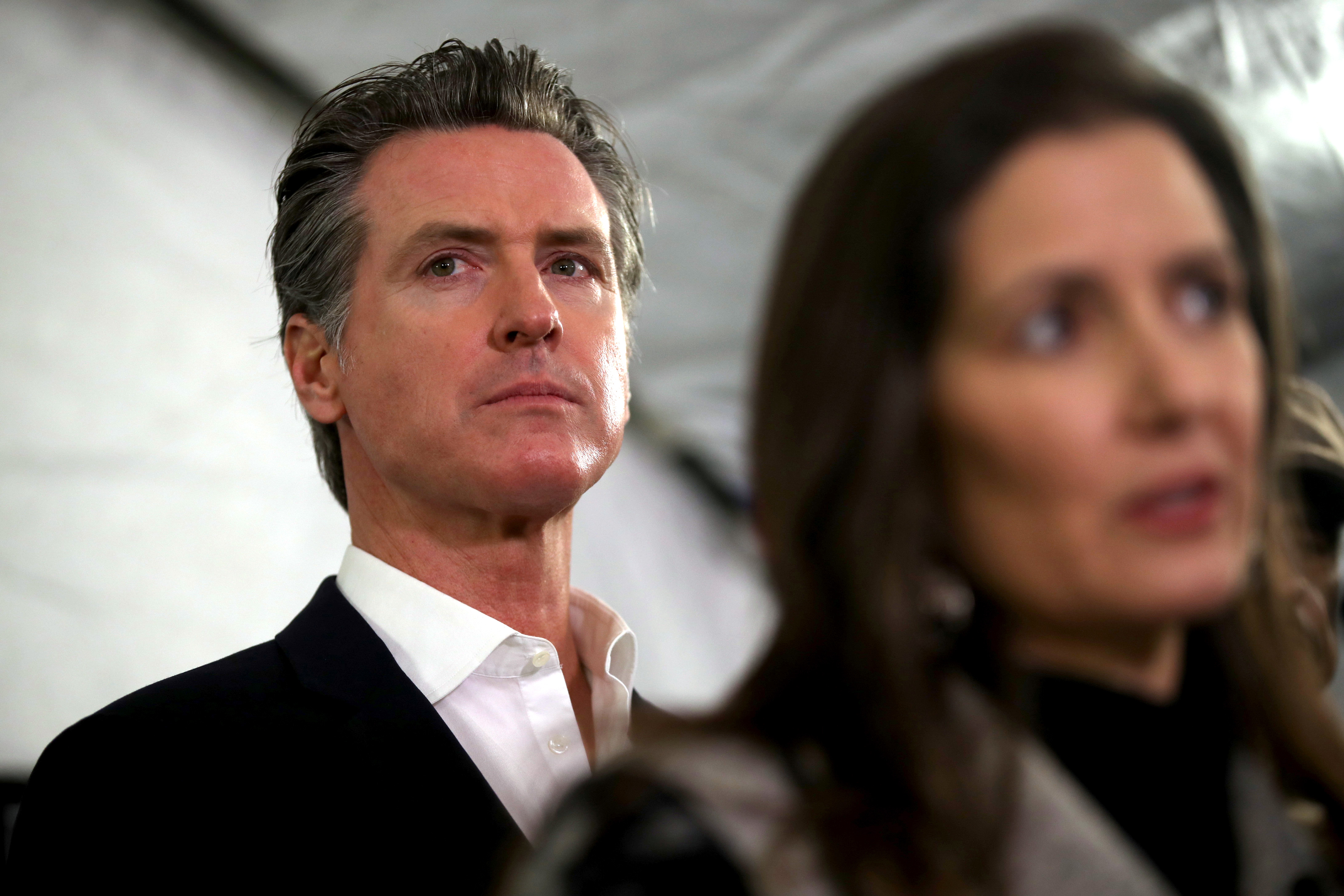 California Gov. Gavin Newsom looks on during a news conference about the state's efforts on the homelessness crisis on January 16, 2020 in Oakland, California. Newsom was joined by Oakland Mayor Libby Schaaf to announce that Oakland will receive 15 unused FEMA trailers for the city to use as temporary housing and as mobile health and social services clinics for the homeless. (Photo by Justin Sullivan/Getty Images)
