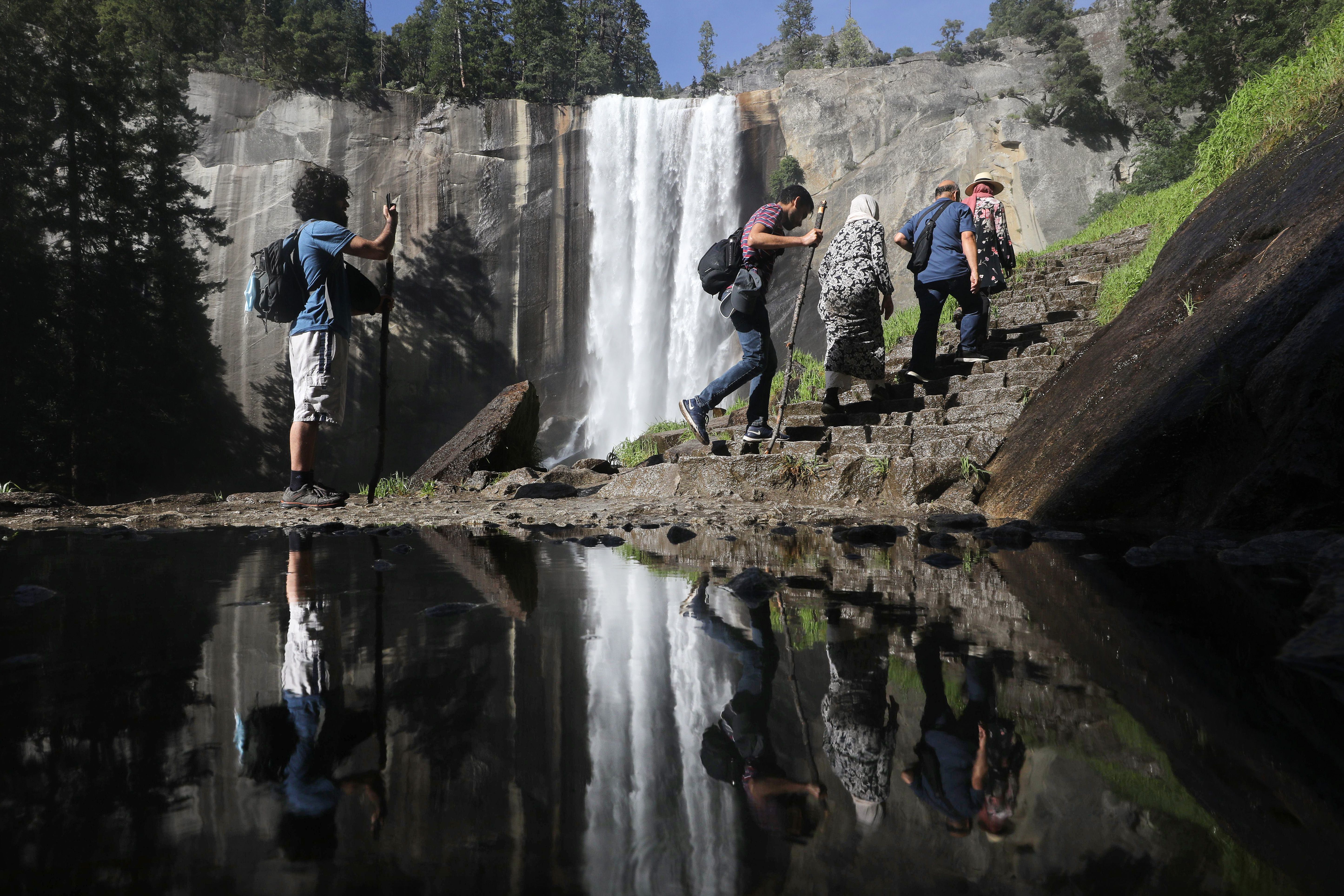 Visitors hike up the Mist Trail toward Vernal Fall on June 19, 2020 in Yosemite National Park. (Photo: Mario Tama/Getty Images)