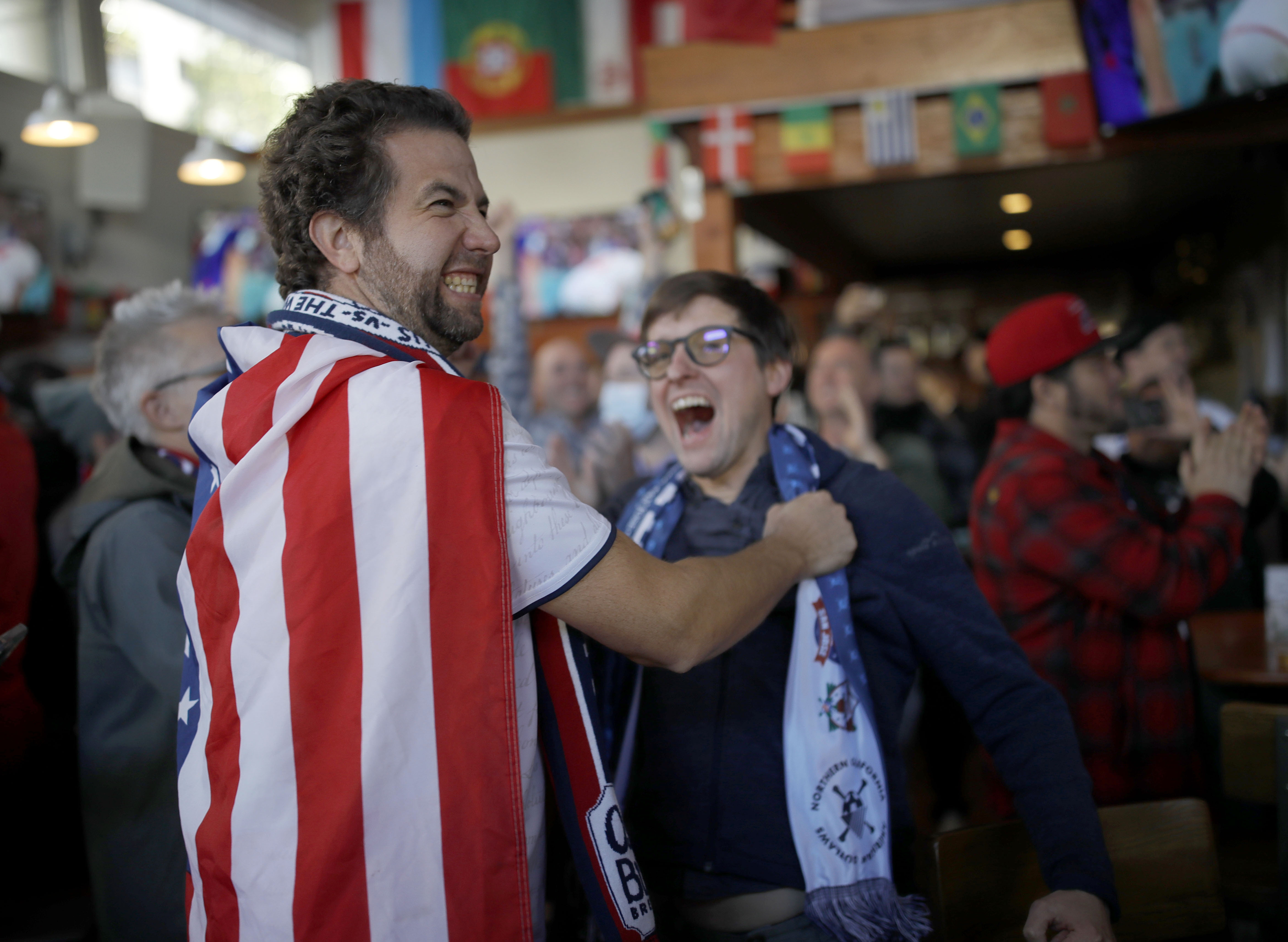 Jason Purdy, of Alameda, left, and Kevin Sweeney, of Oakland, celebrate the United States men's national team's 1-0 victory over Iran during a World Cup watch party at The Athletic Club Oakland in downtown Oakland, Calif., on Tuesday, Nov. 29, 2022. (Jane Tyska/Bay Area News Group)