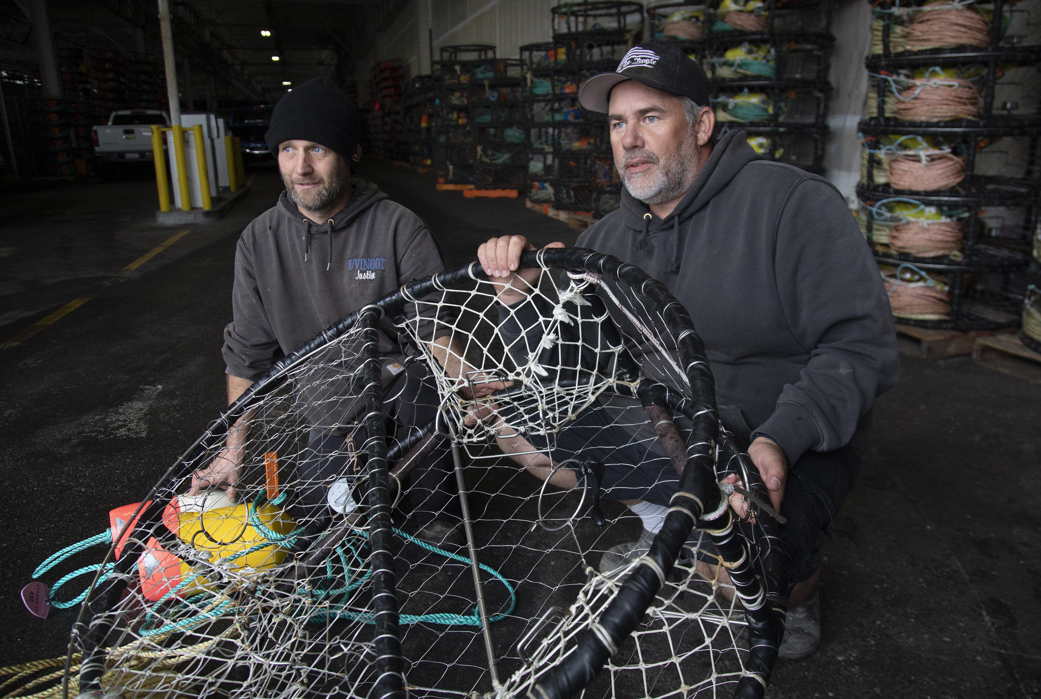 Brand Little, right, shows off a modified, open-top crab pot at Fisherman's Wharf in San Francisco.