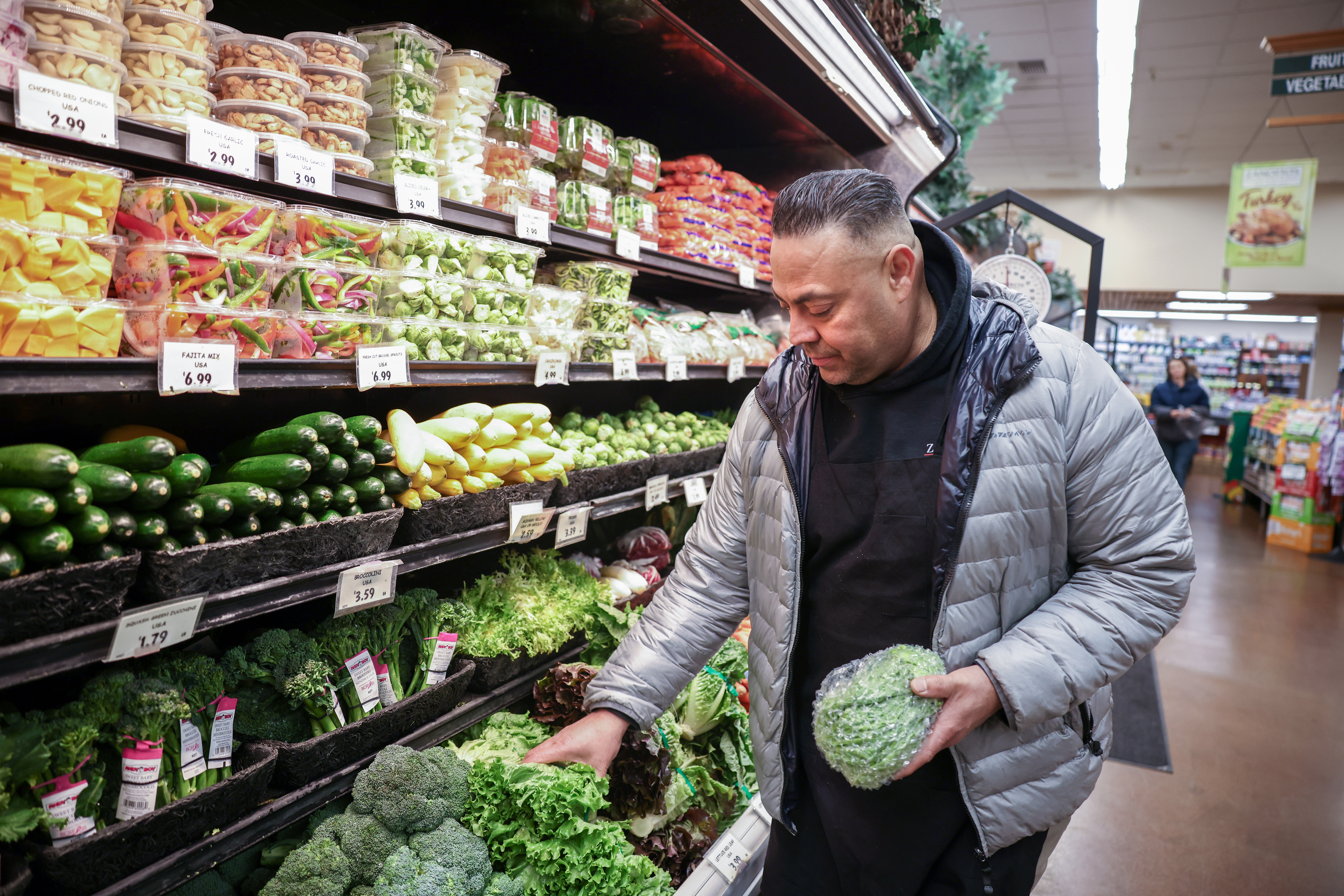 Lorberto Macias, a produce manager at Zanotto's Family Market, arranges lettuce at the market in San Jose, Calif., on Wednesday, Dec. 14, 2022. (Photo: Shae Hammond/Bay Area News Group)