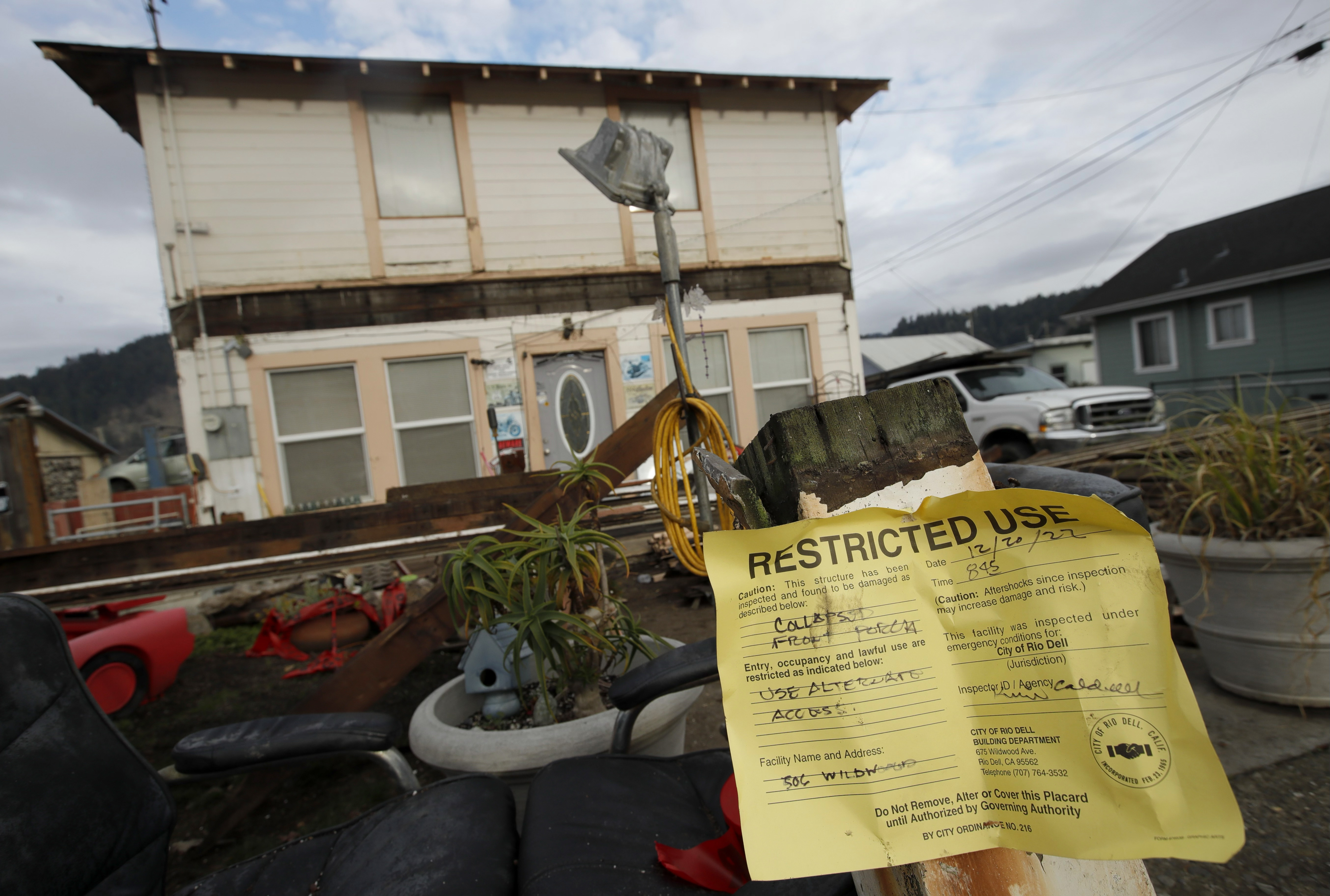 A home is yellow tagged as earthquake damage is seen on Wildwood Avenue in Rio Dell, Calif., on Tuesday, Dec. 20, 2022.