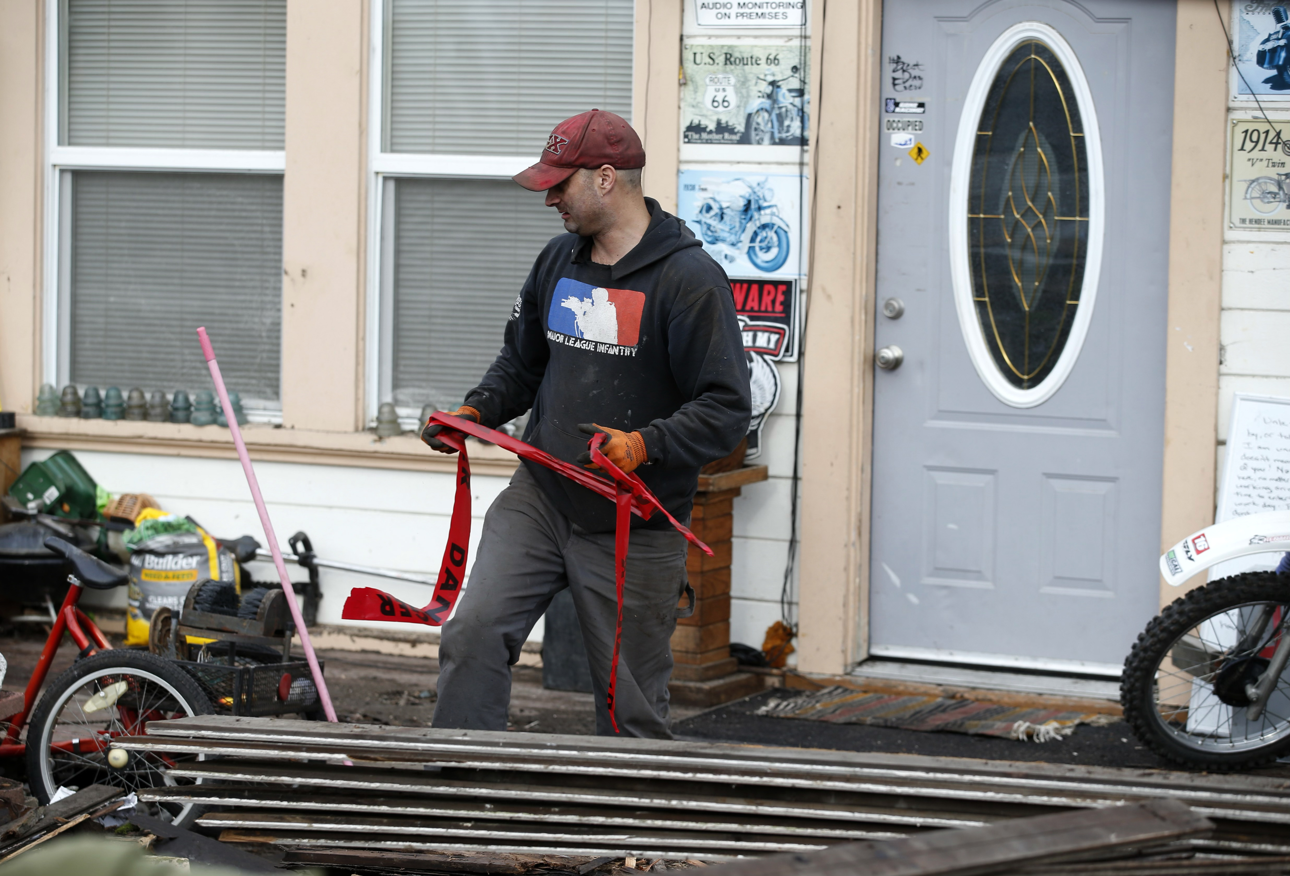 Kyle Chittenden repairs earthquake damage at a friend's house on Wildwood Avenue in Rio Dell, Calif., on Tuesday, Dec. 20, 2022.