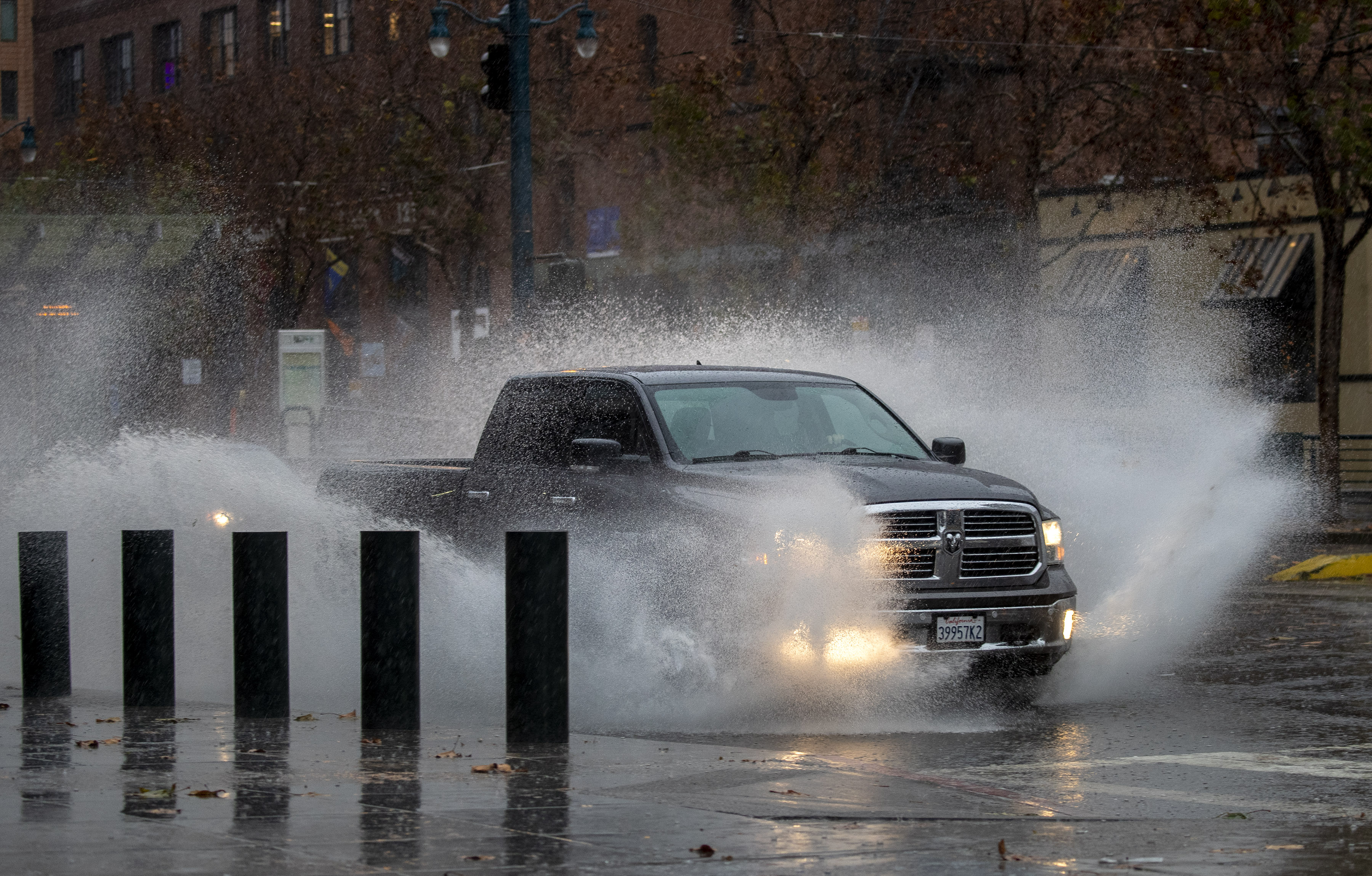 A truck races through puddles covering King Street in San Francisco, Calif., as a storm arrives on Thursday morning, Dec. 1, 2022. (Karl Mondon/Bay Area News Group)
