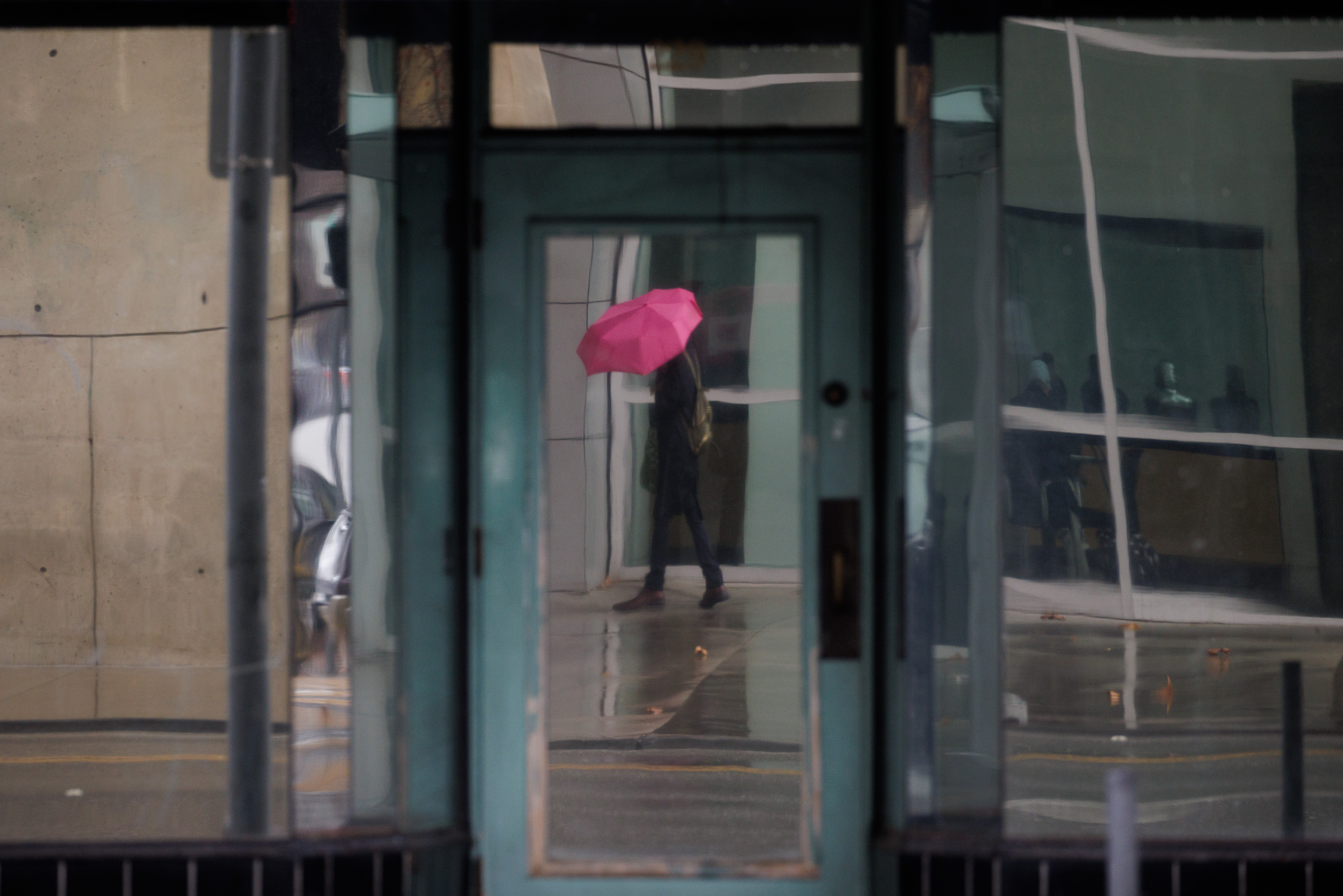 A pedestrian is reflected in a building window on a rainy day in downtown San Jose on Thursday, Dec. 1, 2022. (Dai Sugano/Bay Area News Group)