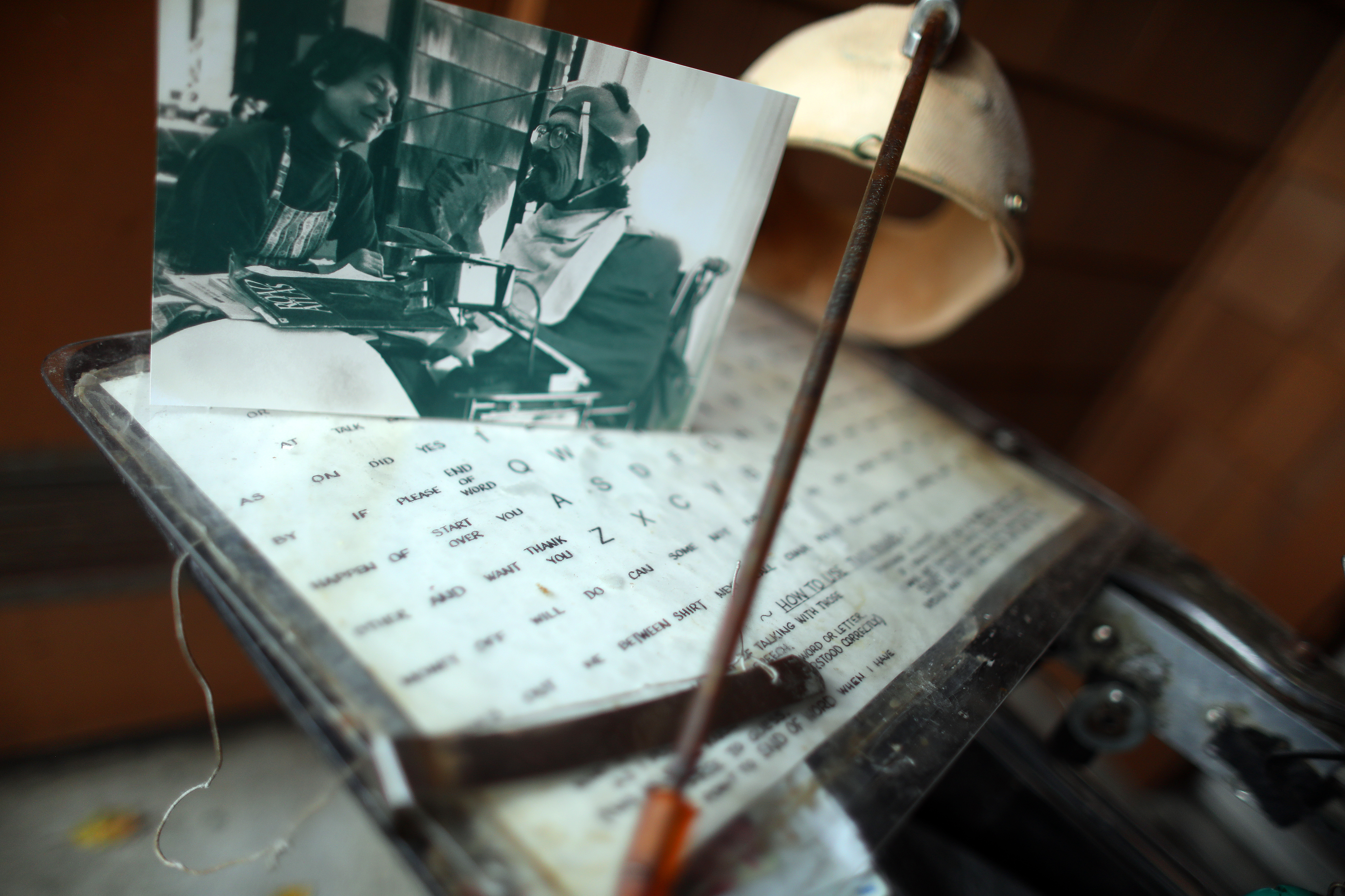 A photograph of Hale Zukas with Nina Sprecher is displayed on a communication board along with a helmet and wand used by Zukas on Monday, Dec. 19, 2022, in Berkeley, Calif. Zukas's communication tools will be sent to the Smithsonian.