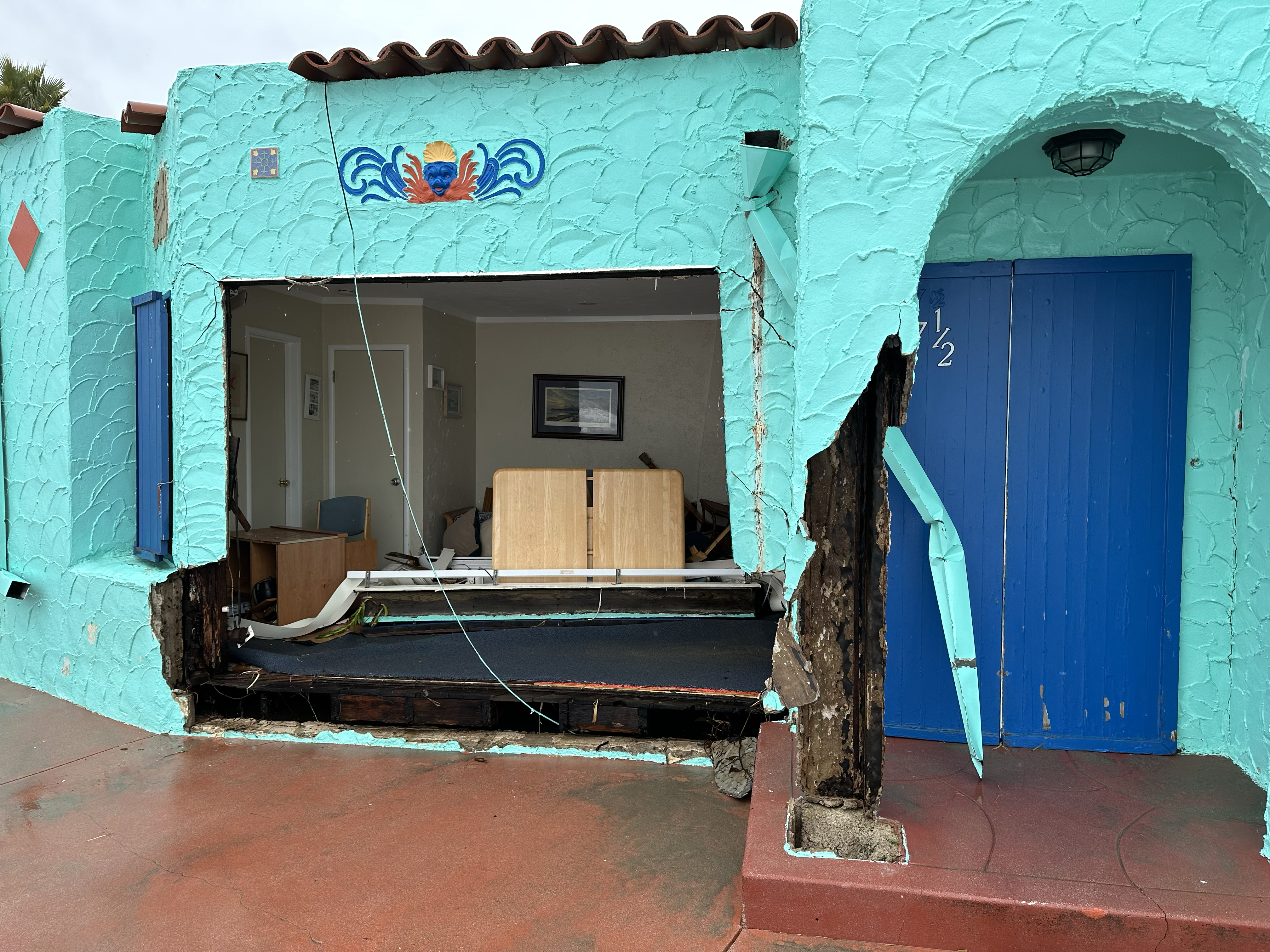 The facade of one of the historic 1924 bungalows along the beachfront in Capitola was demolished by the storm surge and the waterborne logs that likely pummeled it. (Photo by Jim Downey)