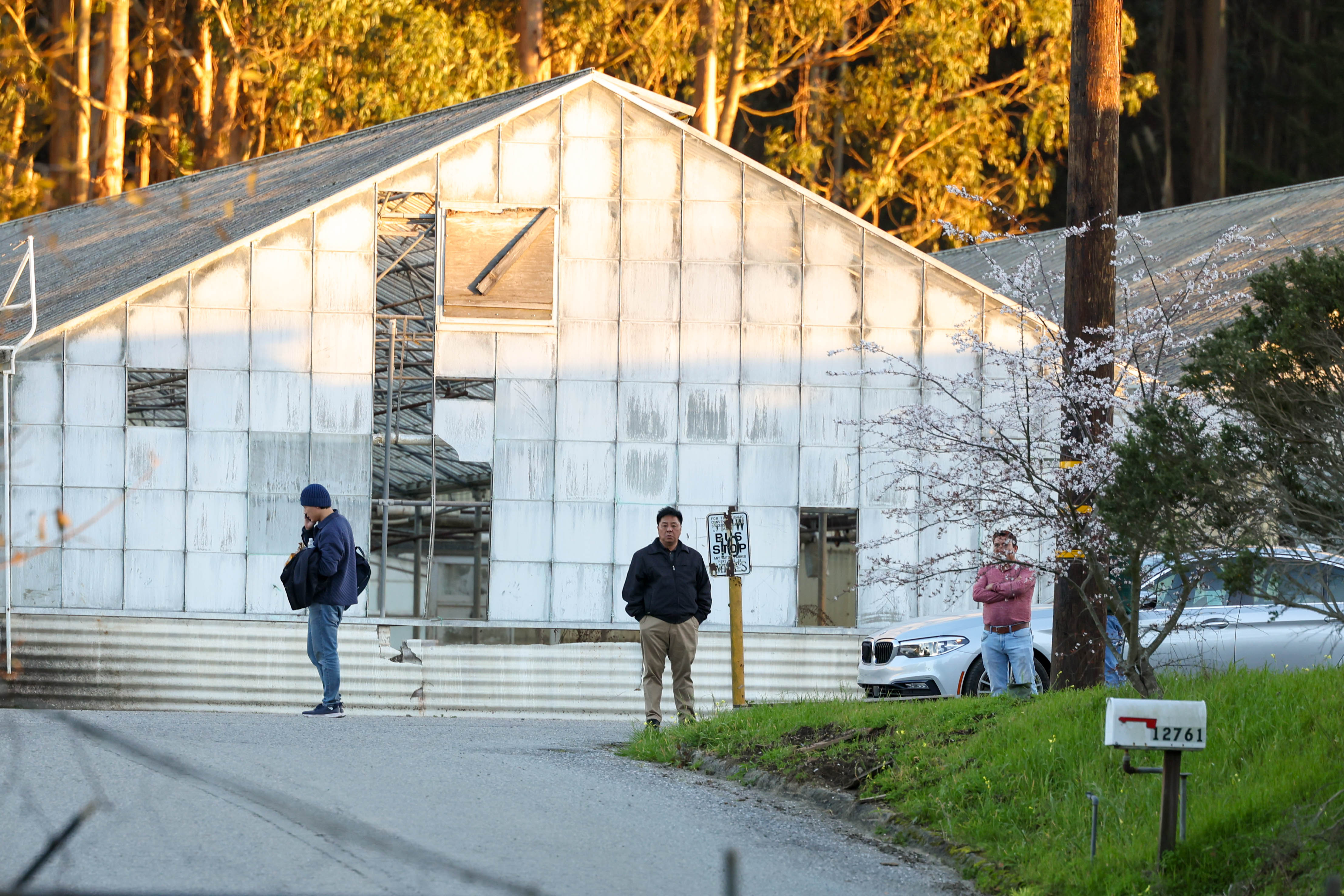 Men stand on at the California Terra Gardens farm entrance in Half Moon Bay, Calif., on Thursday, Jan. 26, 2023. Chunli Zhao, 66, who allegedly lived and worked there, has been charged with seven counts of murder and one count of attempted murder for the mass shooting on Monday. (Ray Chavez/Bay Area News Group)