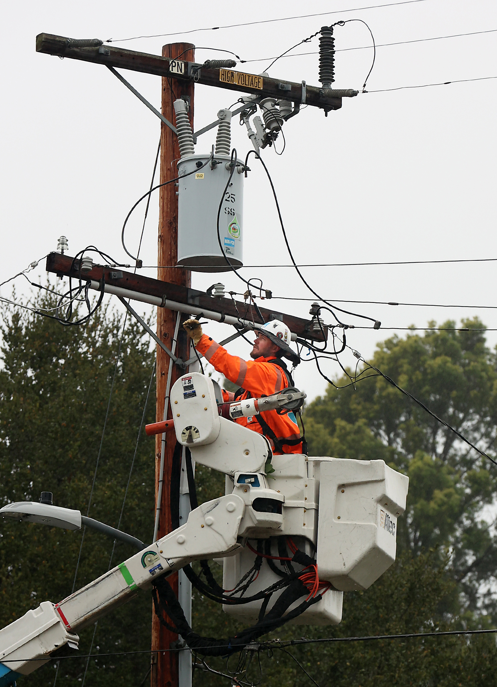 A PG&E worker keeps the power on in Santa Cruz on Wednesday. 