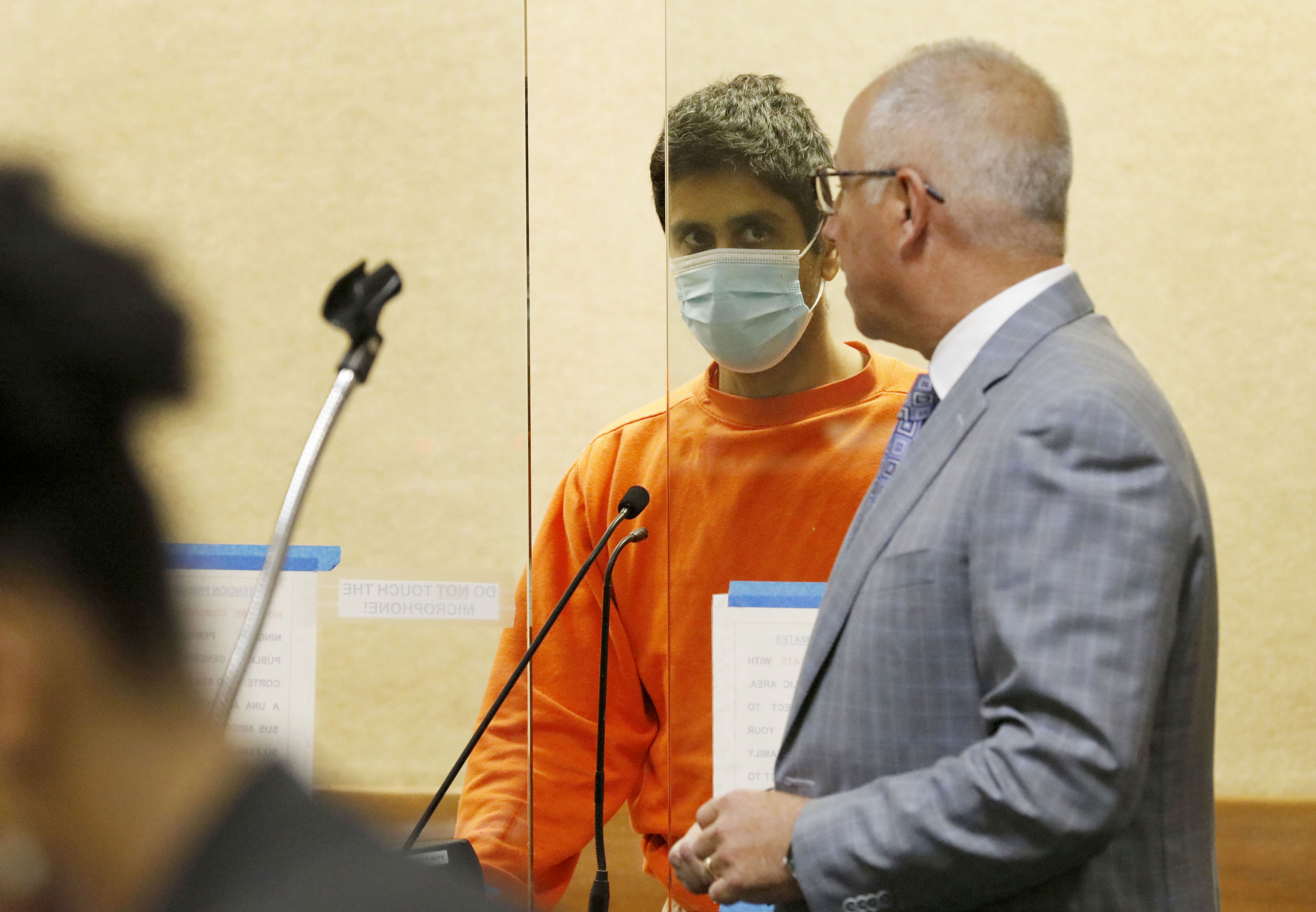 Dharmesh Patel and his Defense Attorney Joshua Bentley inside the courtroom during Patel's court proceeding in Redwood City, Calif., on Thursday, February 9, 2023. Patel, who drove a Tesla over a cliff with his two children and wife in the car is being charged with attempted murder.