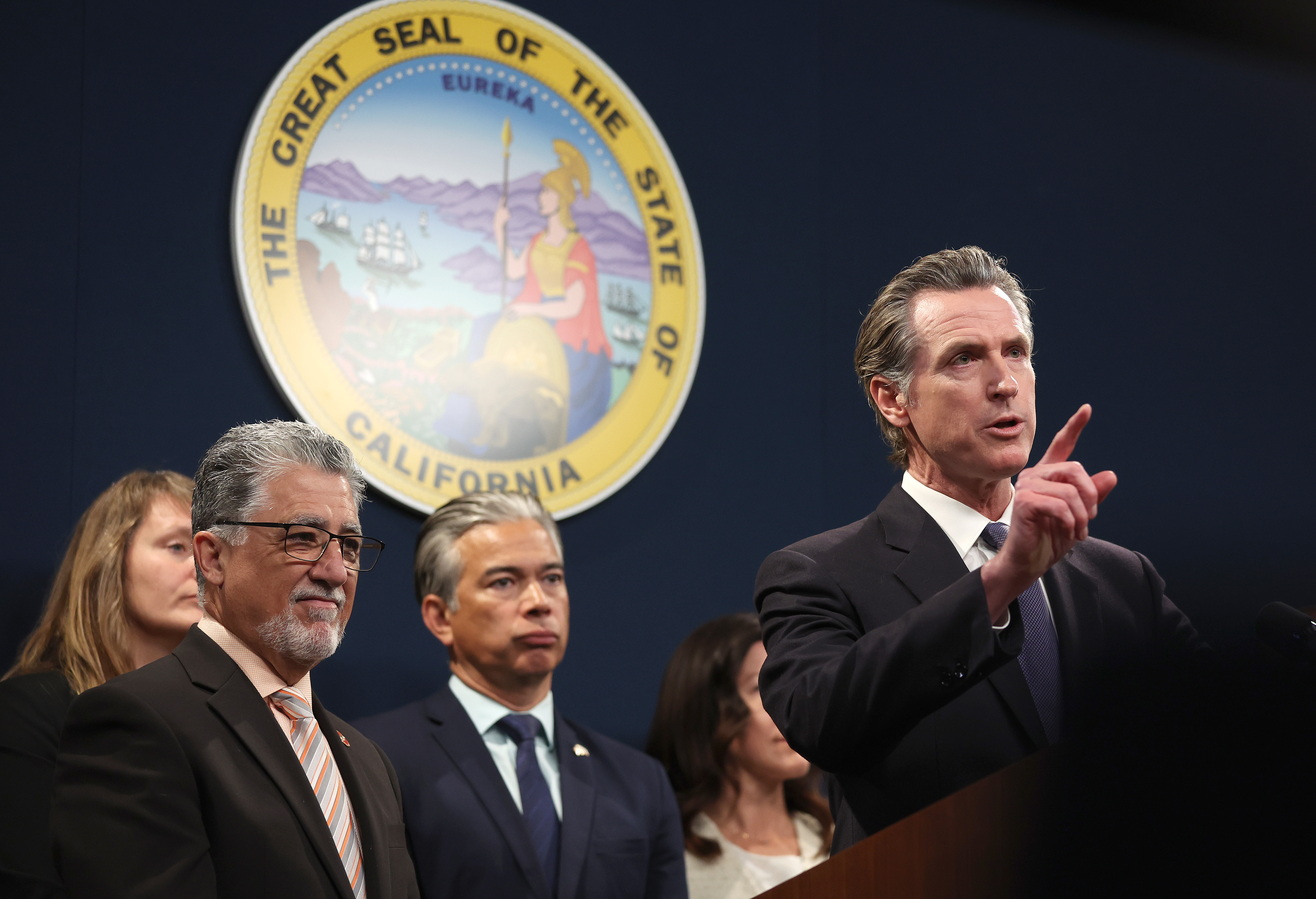 California Gov. Gavin Newsom (R) speaks as state Senator Anthony Portantino (L) (D-Burbank) and California Attorney General Rob Bonta (C) look on during a press conference on February 01, 2023 in Sacramento, California. California Gov. Gavin Newsom, state Attorney General Rob Bonta, state Senator Anthony Portantino (D-Burbank) and other state leaders announced SB2 - a new gun safety legislation that would establish stricter standards for Concealed Carry Weapon (CCW) permits to carry a firearm in public. The bill designates "sensitive areas," like bars, amusement parks and child daycare centers where guns would not be allowed. (Photo by Justin Sullivan/Getty Images)