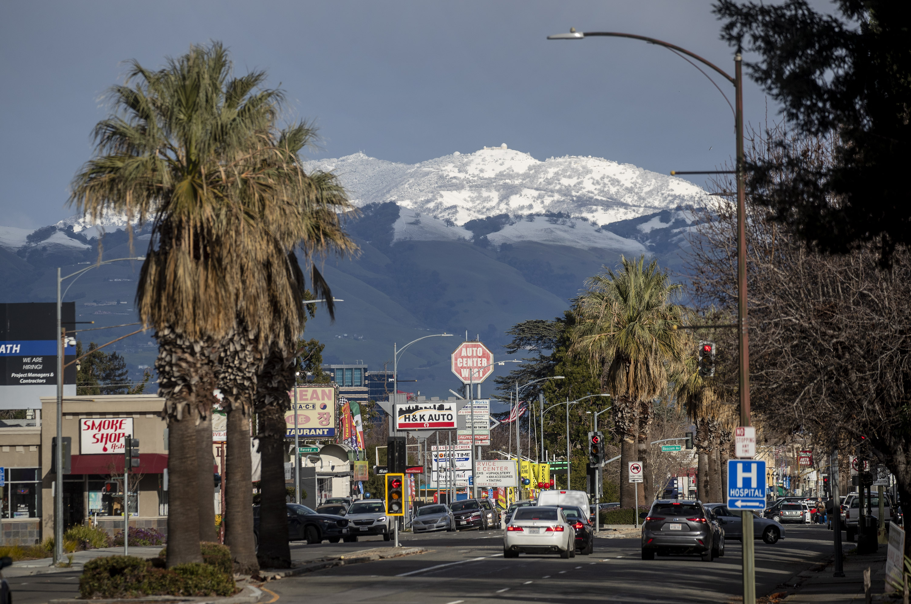 Snow-capped Mount Hamilton rises above San Jose, Calif., in a view down West San Carlos Street, Friday, Feb. 24, 2023.