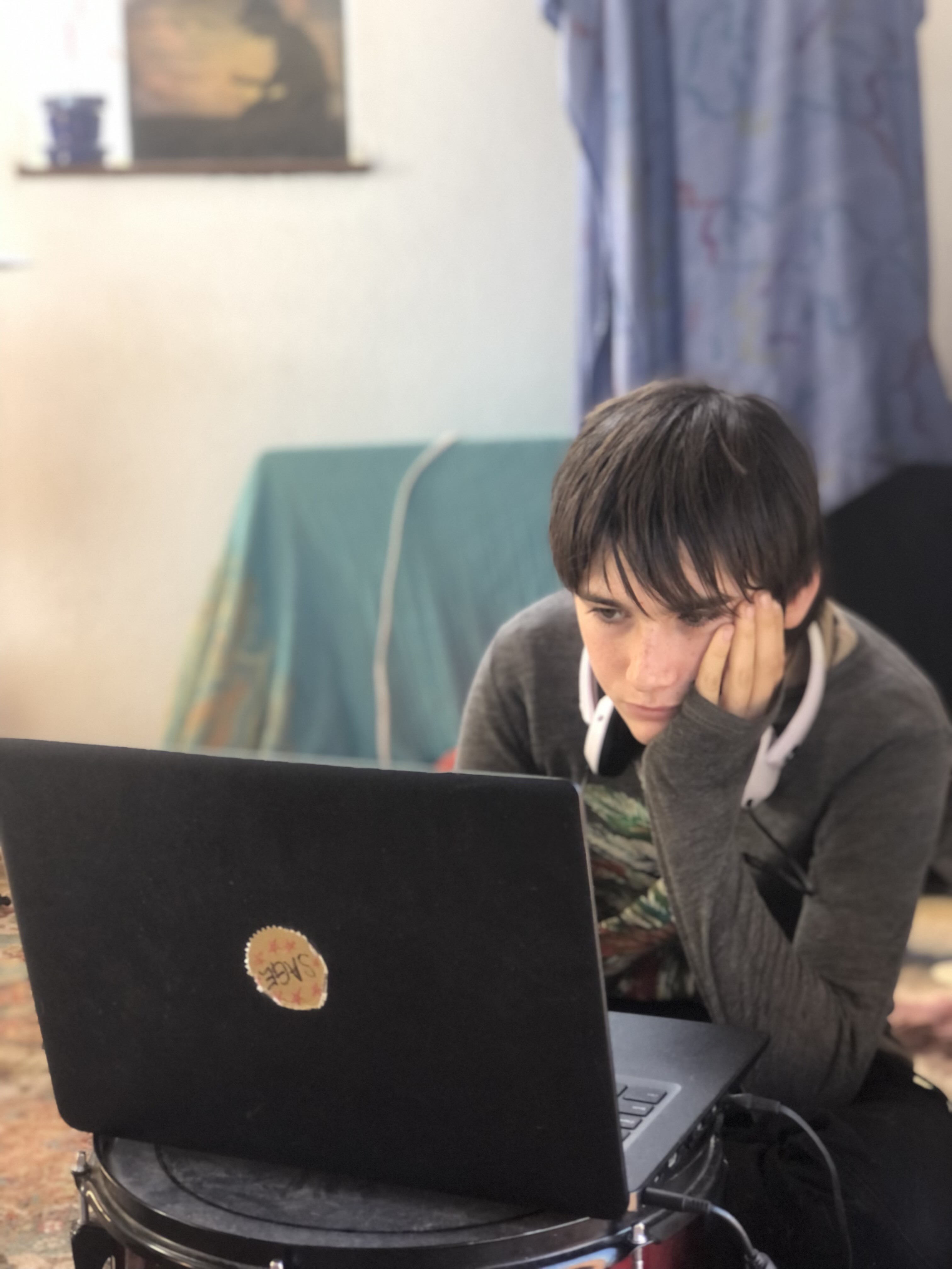 Sage Harvey, age 11, tunes into online classes on March 1, 2023 -- two months after a series of landslides caused his school to shut down to in-person learning in Big Sur, California.