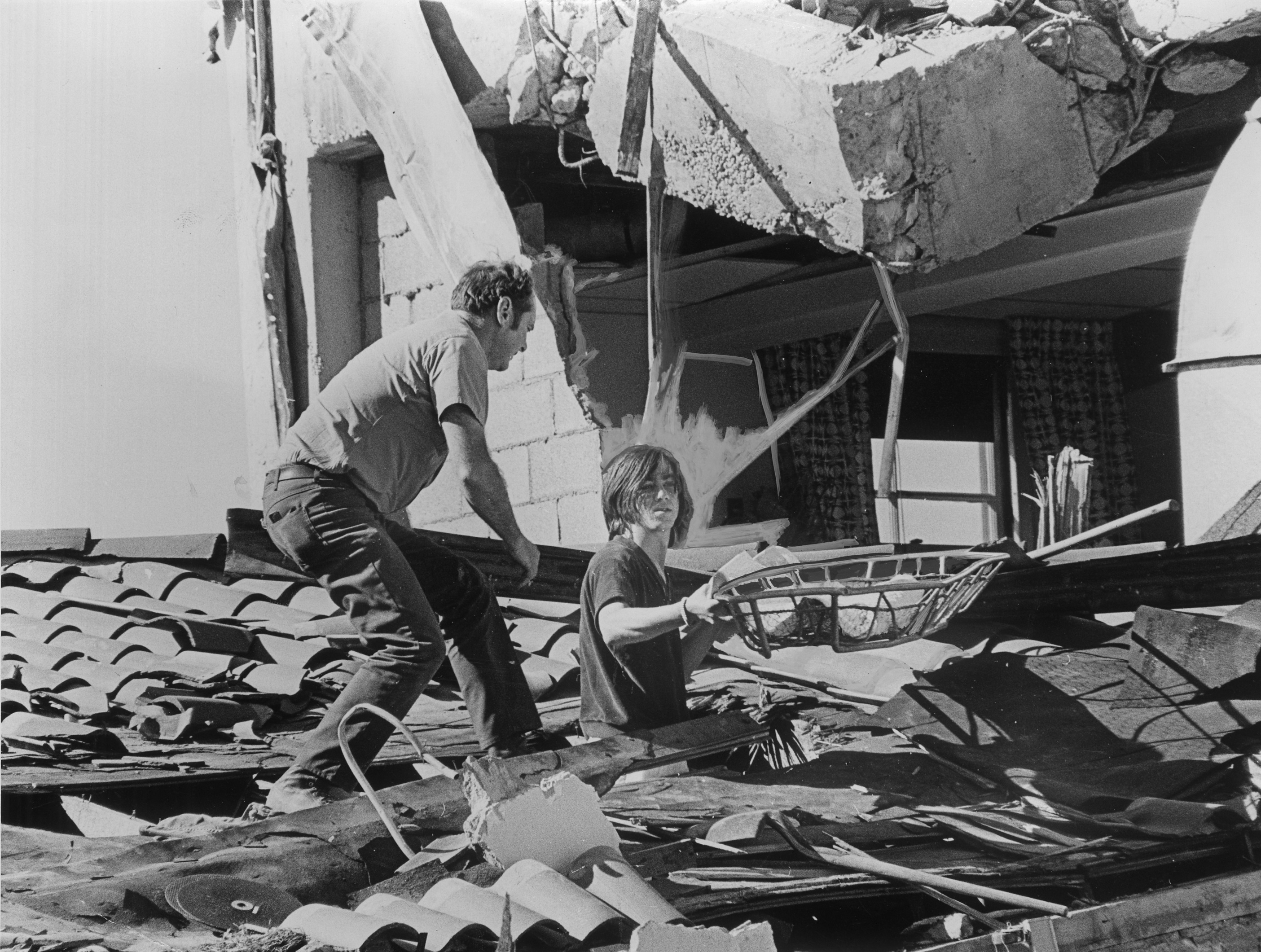 Rescue efforts take place at the Veterans Hospital in Sylmar after the 1971 San Fernando earthquake. Bill Walker, center, 22, a patient at the hospital, was pinned to his bed following the quake. After he freed himself, he joined the rescue effort.