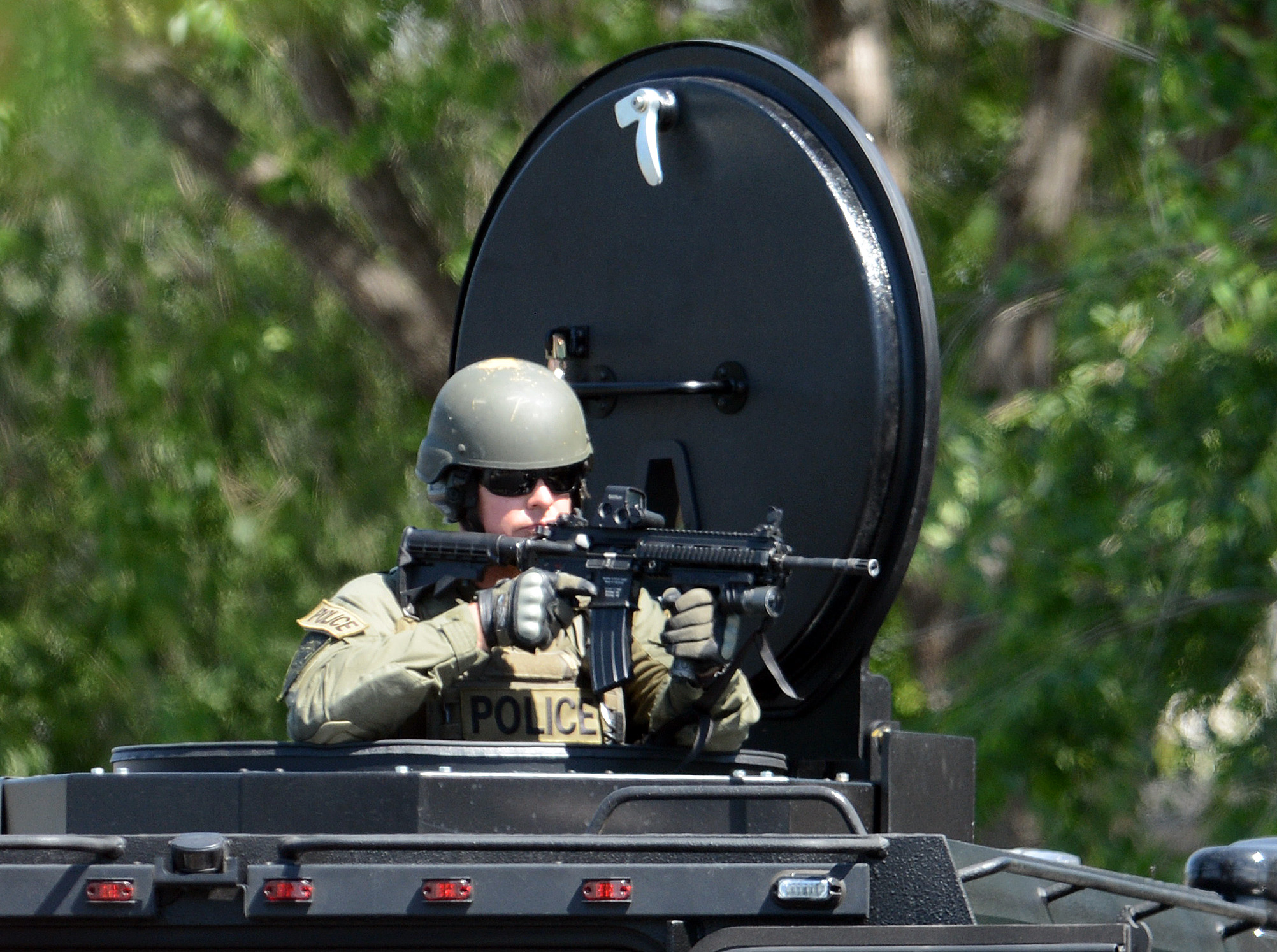 A member of the Livermore Police Special Weapons And Tactics (SWAT) team keeps watch as the Livermore Police Special Operations Unit raids a home where occupants were suspected of selling methamphetamine, in 2013 in Livermore, Calif.