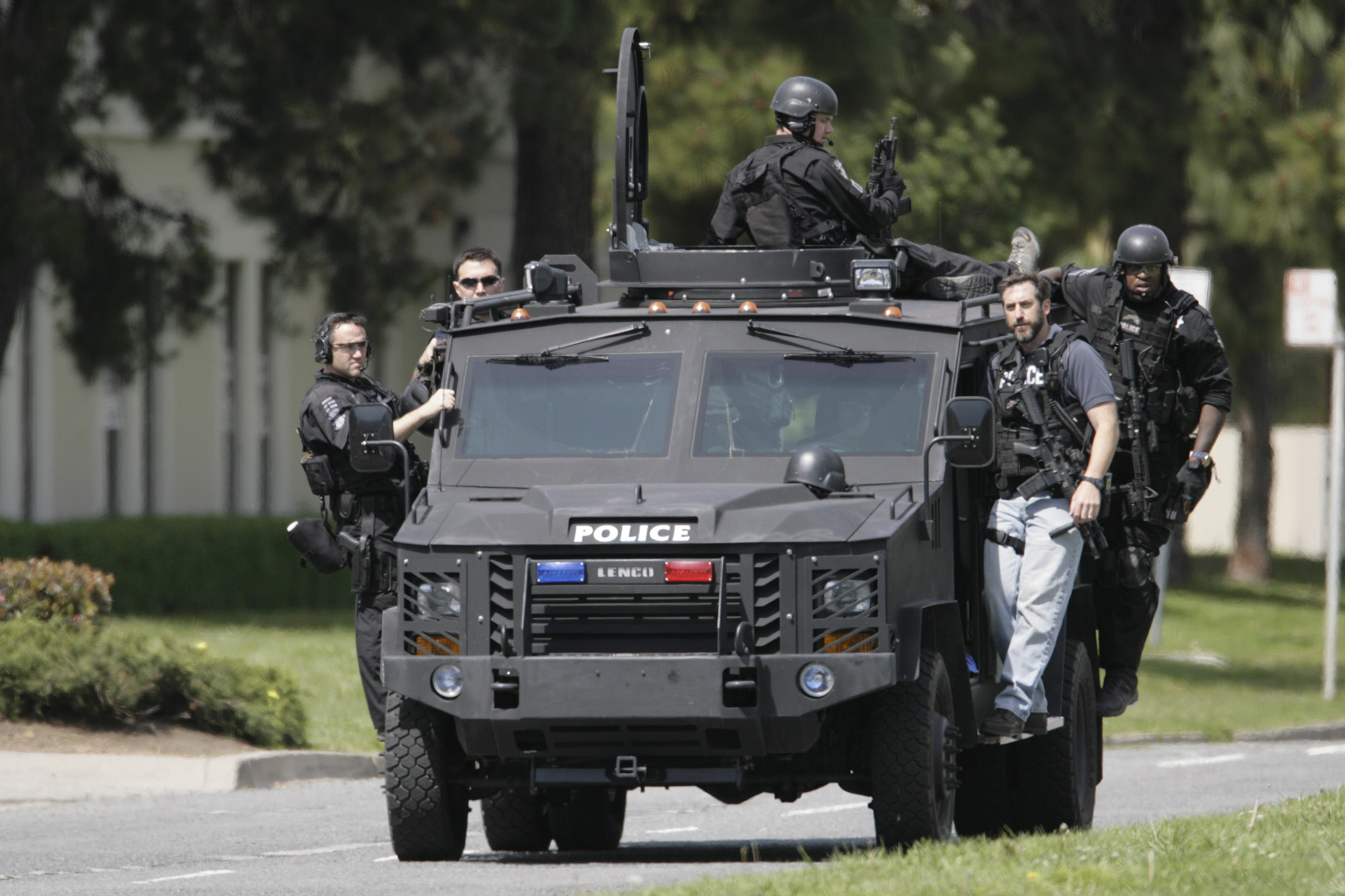 A SWAT team from the Oakland Police Department leaves the scene of a mass shooting on an armored truck at the Oikos University on Edgewater Drive in Oakland, Calif. on Monday, April 2, 2012.