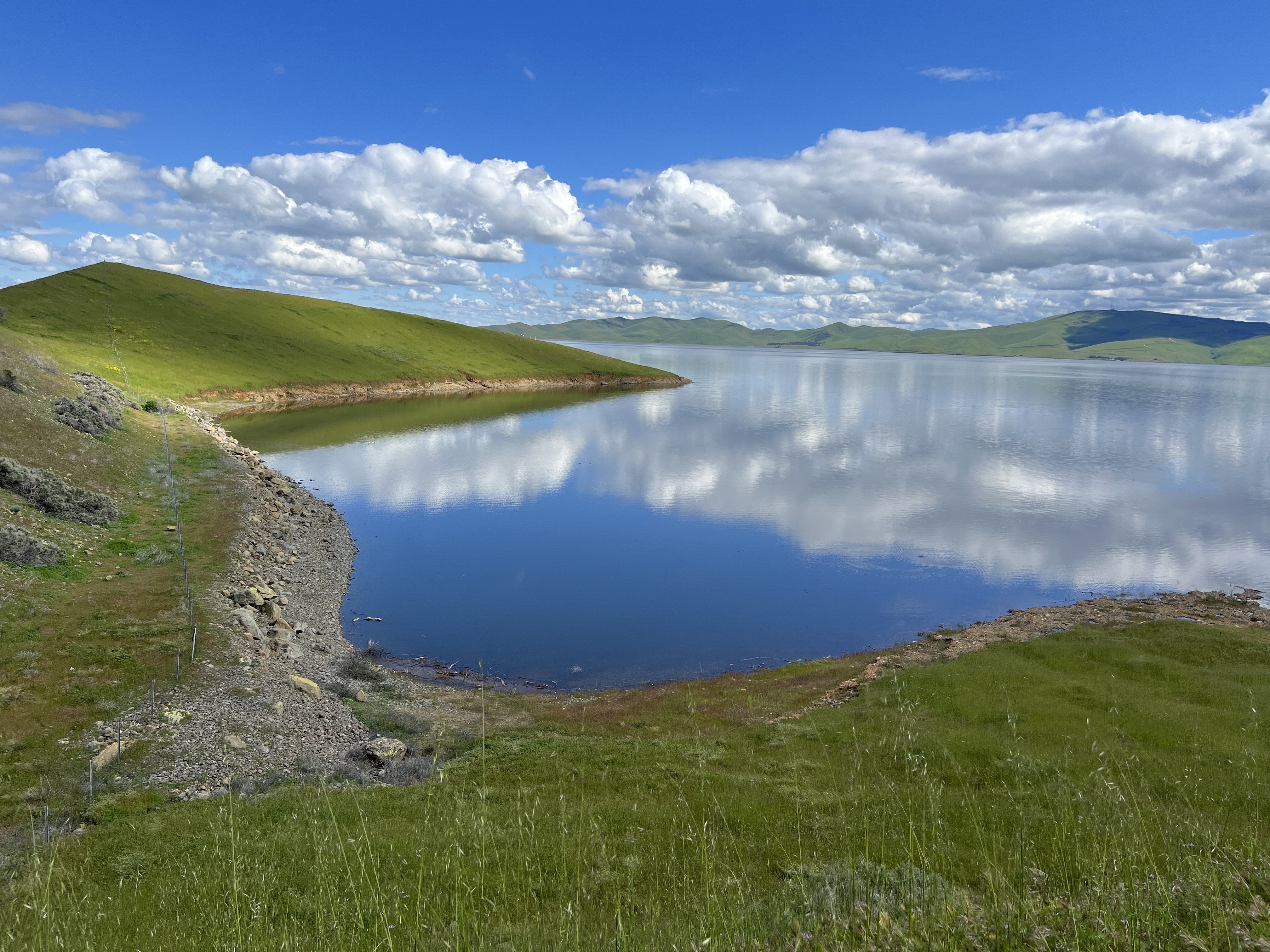 Clouds reflect off the water at the San Luis Reservoir on Thursday, March 30, 2023.