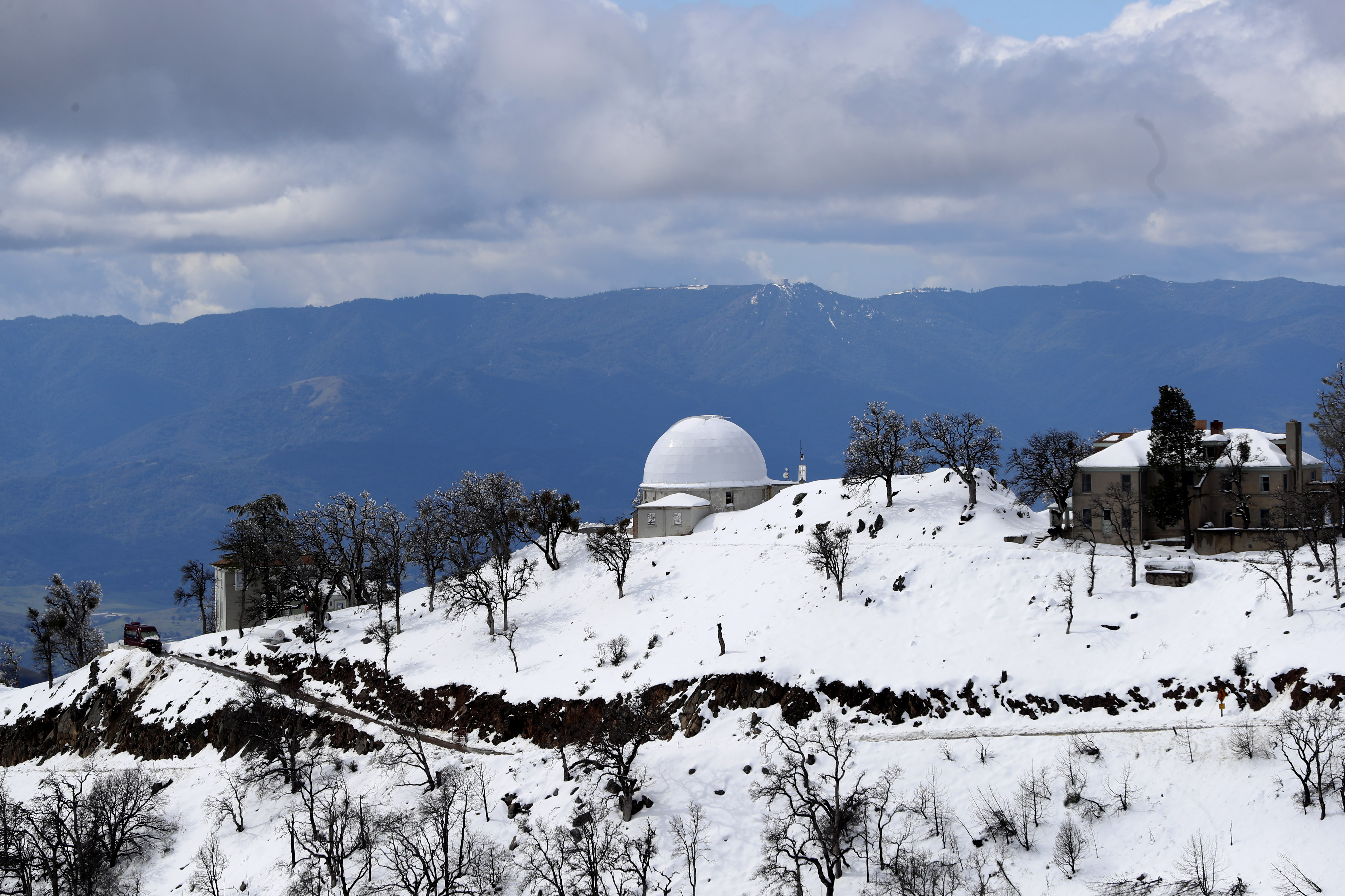 The snow-capped Lick Observatory atop Mount Hamilton looks out across the valley to the Santa Cruz Mountains and Mount Umunhum, Tuesday, March 7, 2023.