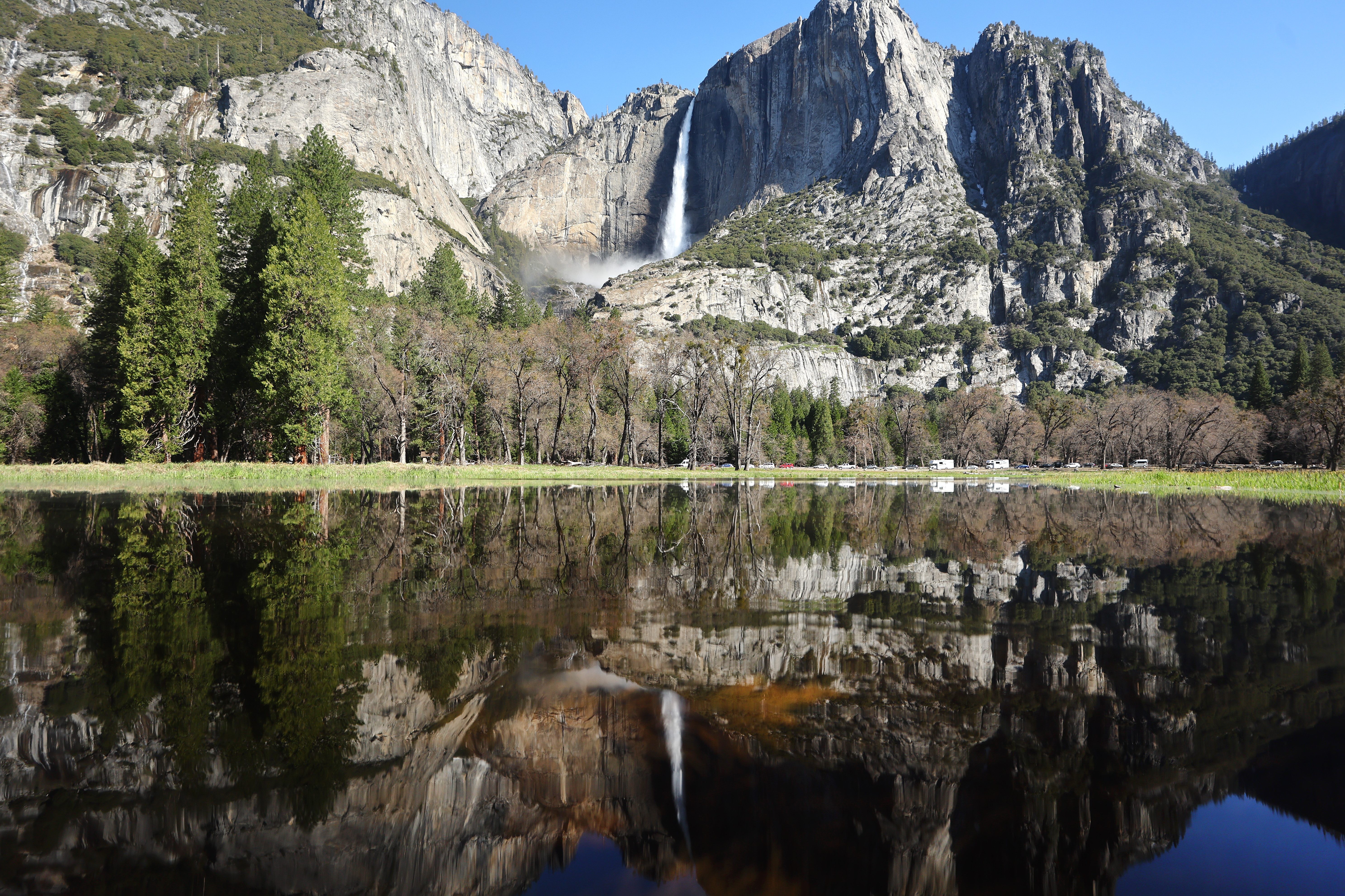 Yosemite Falls is reflected in a meadow which is beginning to flood in Yosemite Valley, as warming temperatures have increased snowpack runoff, on April 28, 2023 in Yosemite National Park, California. Most of Yosemite Valley will close this evening until May 3rd because of forecasted flooding from melting snowpack and extended high temperatures. Yosemite Falls is fed almost completely by snowmelt and is the tallest waterfall in North America when measured from the peak of the upper fall to the base of the lower fall. As of April 1, snowpack in the Tuolumne River basin of Yosemite National Park was 244% of average amid record snowpack levels for some parts of California after years of drought. (Photo by Mario Tama/Getty Images)