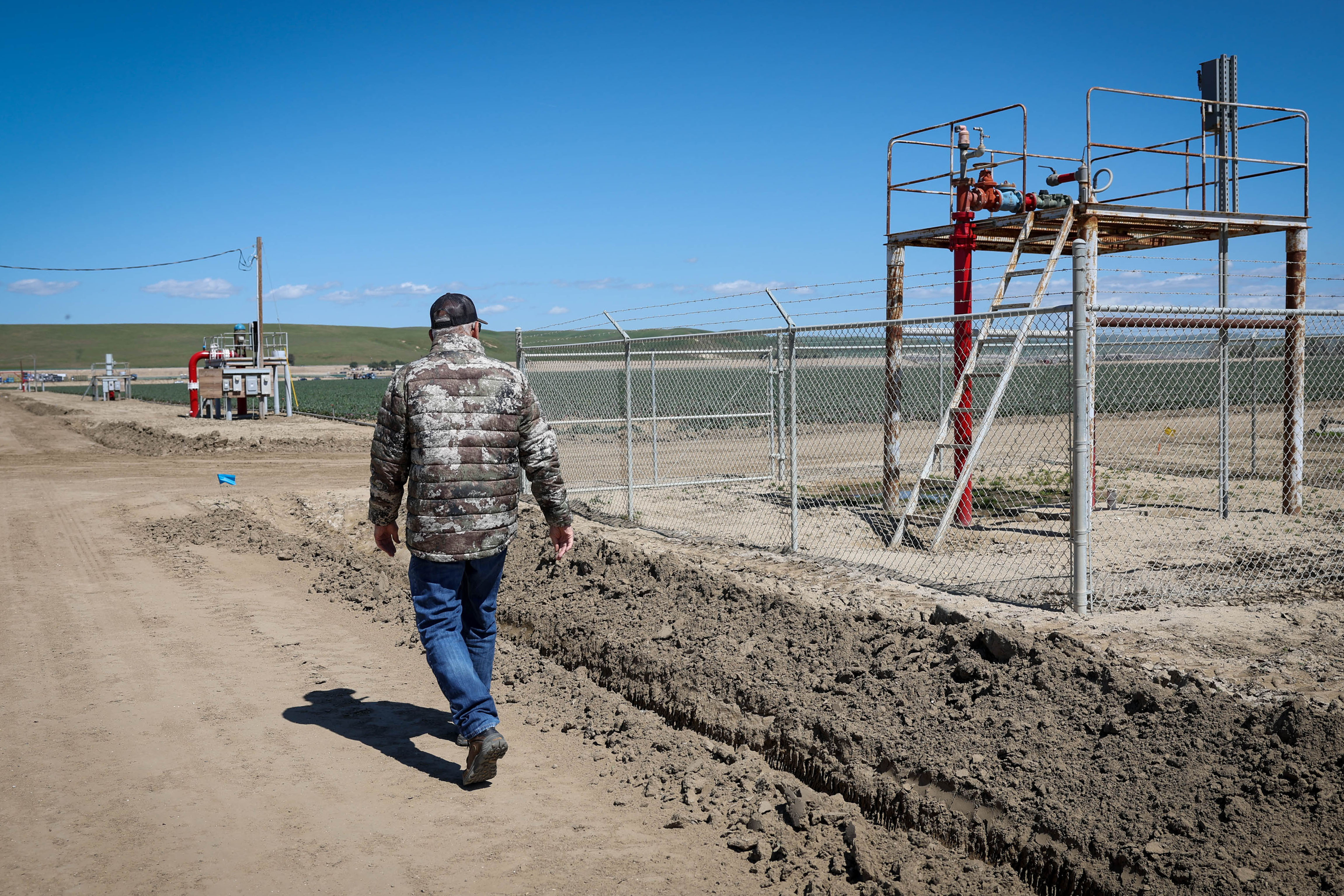 John Romans, farmer for Mission Ranches, walks towards the water well that provides non-potable water to San Lucas, Calif., on Thursday, April 14, 2023.